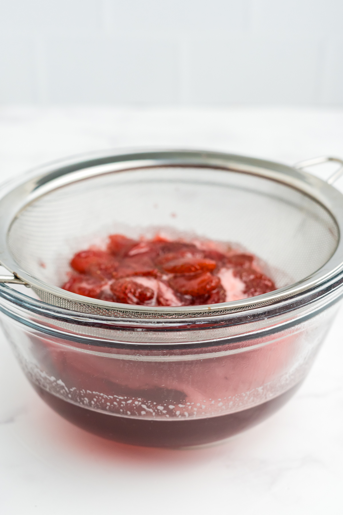 Syrup strained into a bowl.