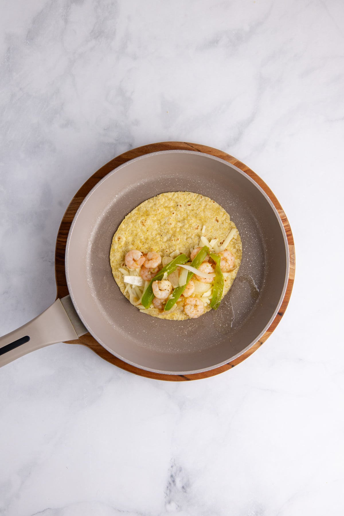 The filling on a tortilla in a skillet.