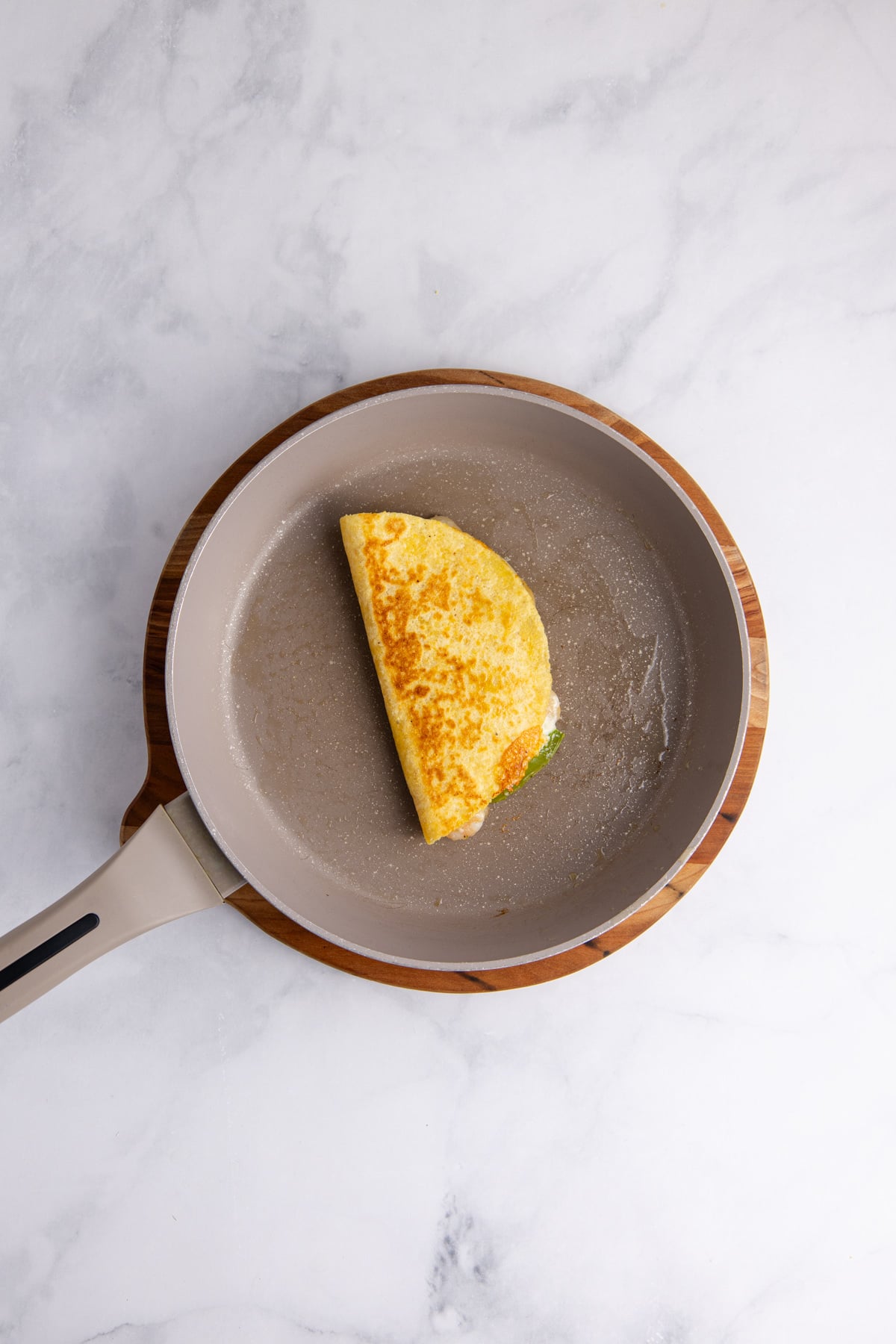 The tortilla folded over and toasted on the other side.