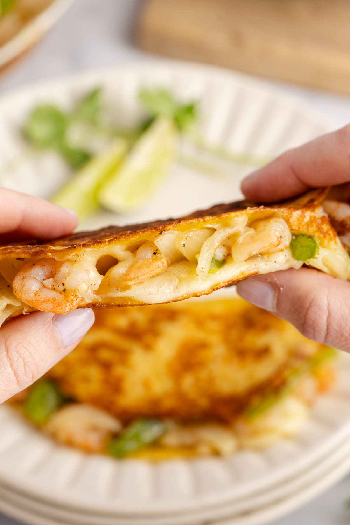 Hands holding up a shrimp taco.