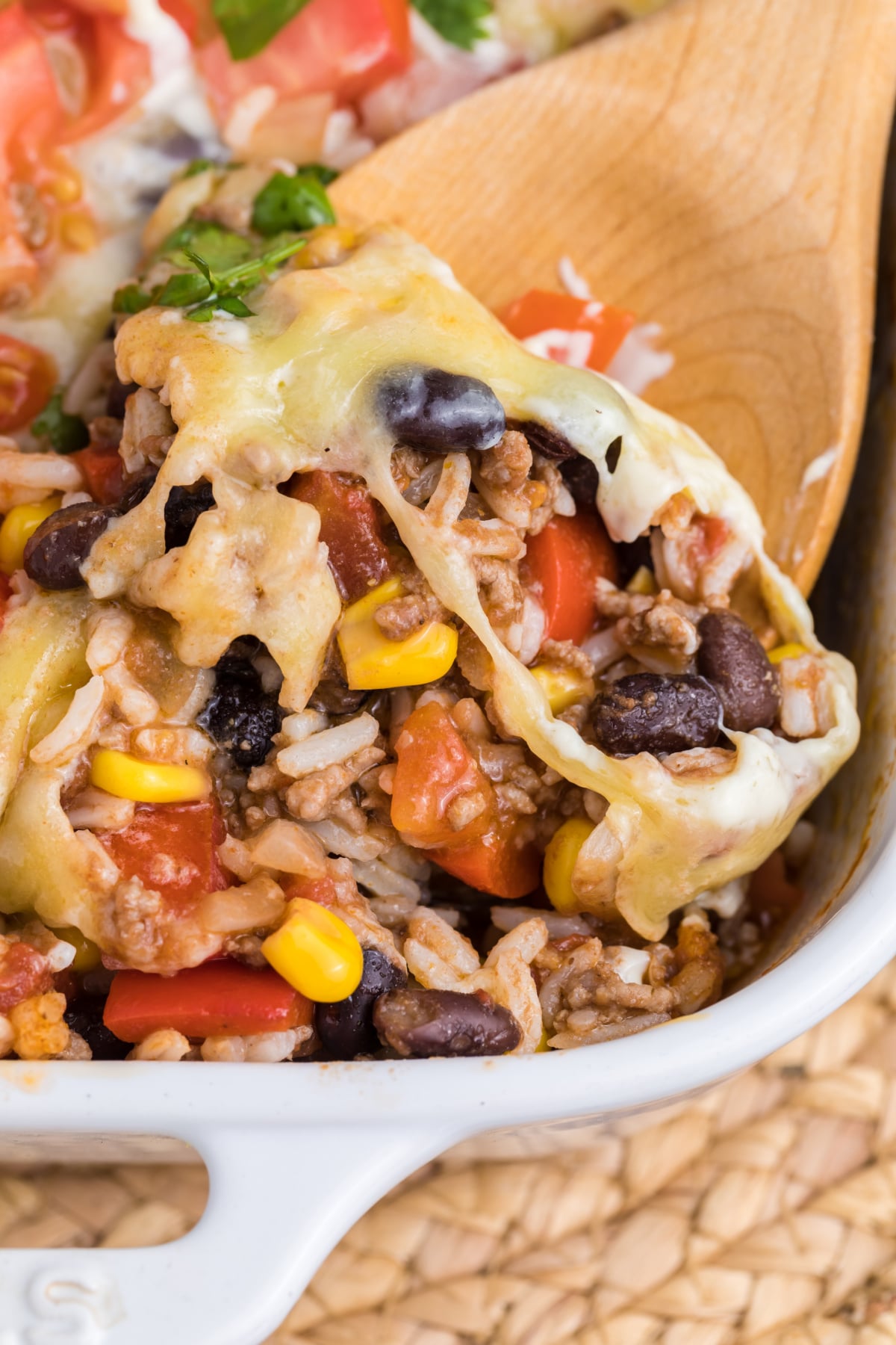 A taco casserole with beans, rice, ground beef, and cheese.