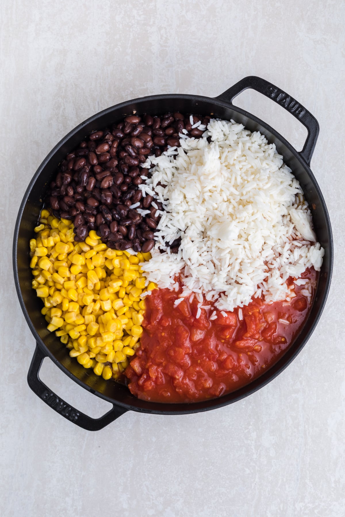 Black beans, diced tomatoes, corn kernels and rice added to the ground beef.