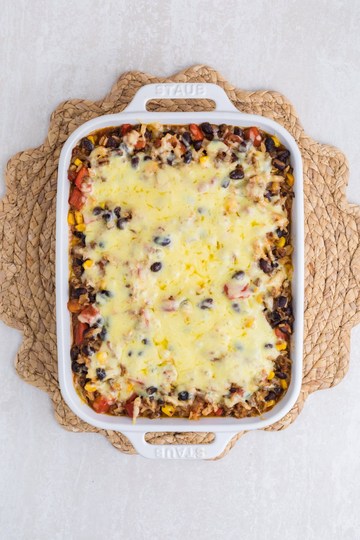 Shredded cheese sprinkled on top of the casserole.