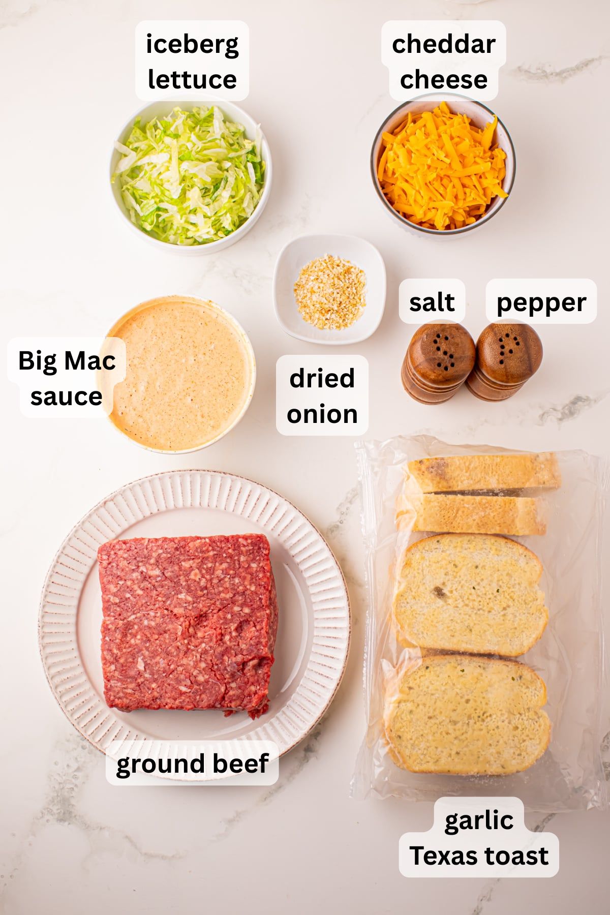 All the ingredients needed to make a Texas Toast Big Mac in bowls and plates on a counter.