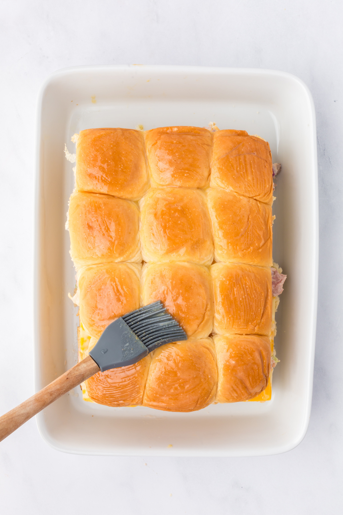 Melted butter brushed on top of sliders with a sprinkling of garlic powder.