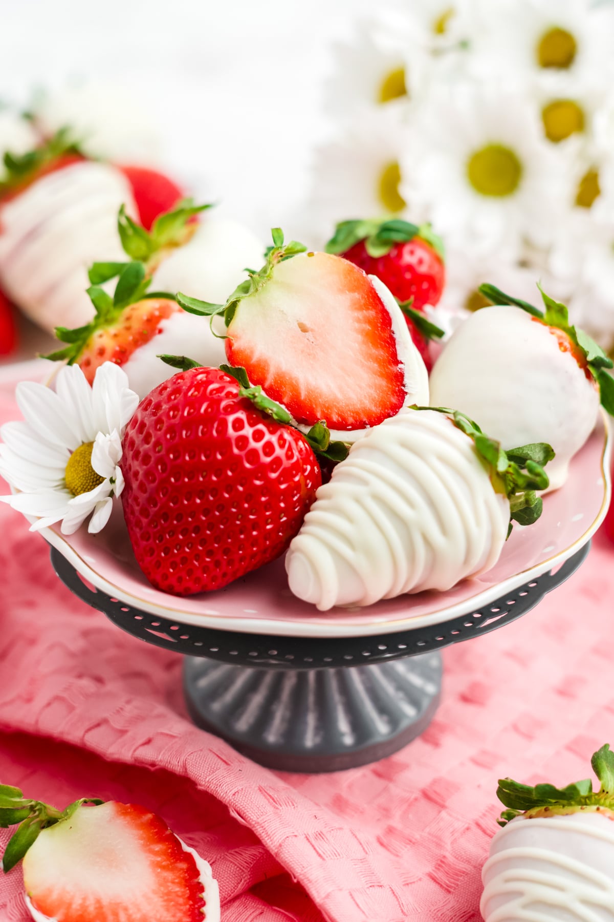 A tray filled with strawberries dipped in white chocolate.