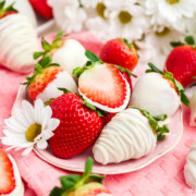 A plate filled with white chocolate strawberries.