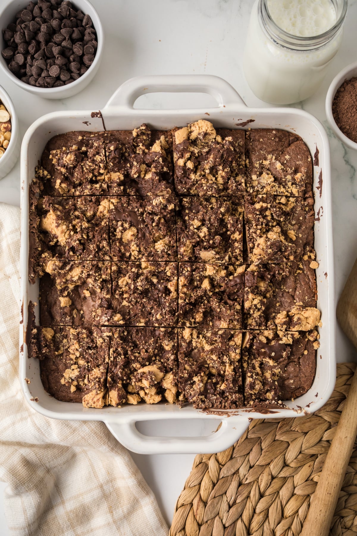 Chocolate mixed with peanut butter mixture on top of brownies.