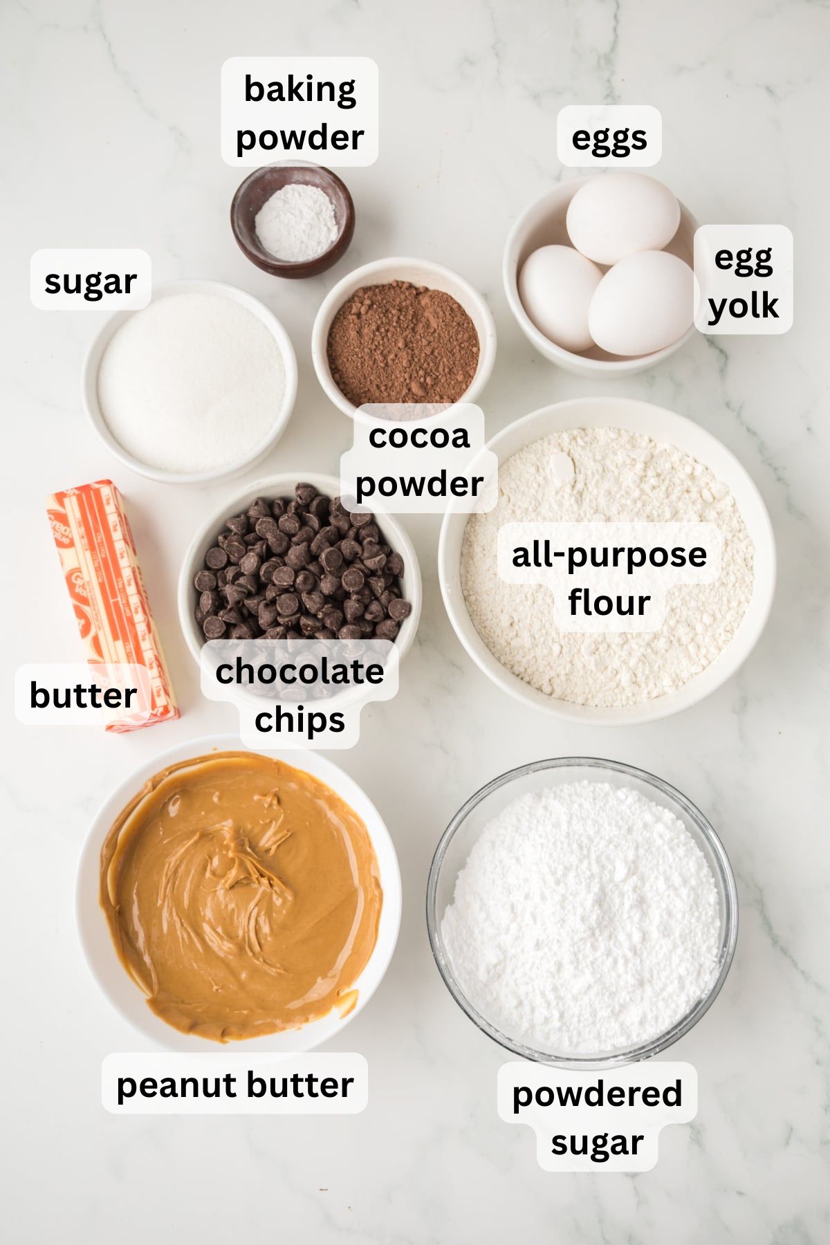 All of the Ingredients to make Buckeye Brownies on a table in bowls.