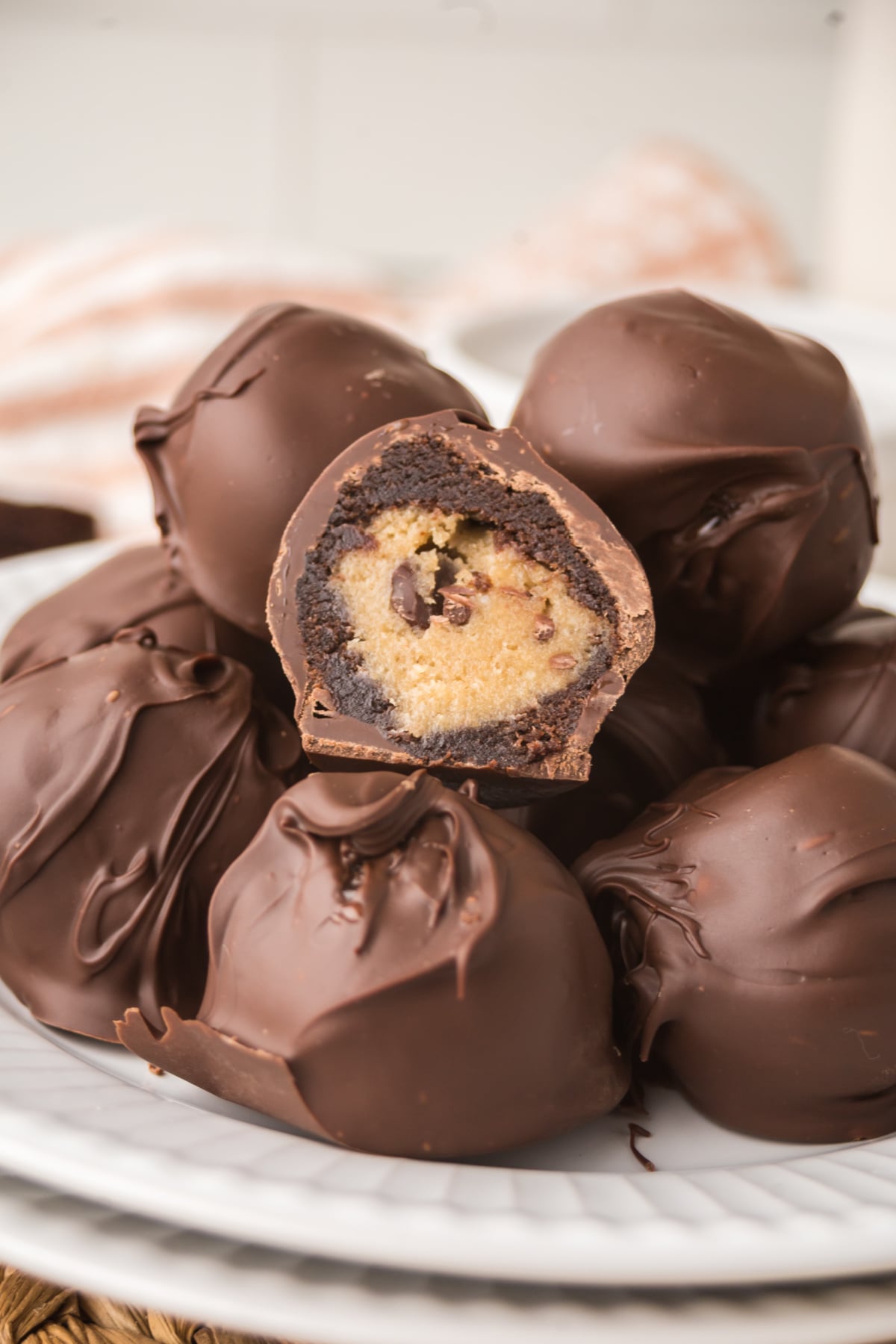 A pile of Chocolate Chip Bites on a plate with the top one missing a bite.