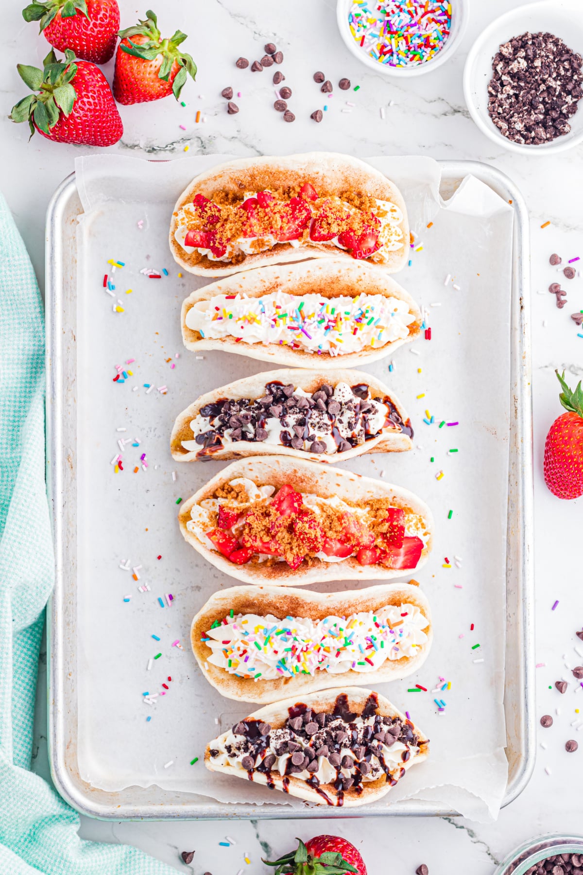 Tacos being topped with different toppings.
