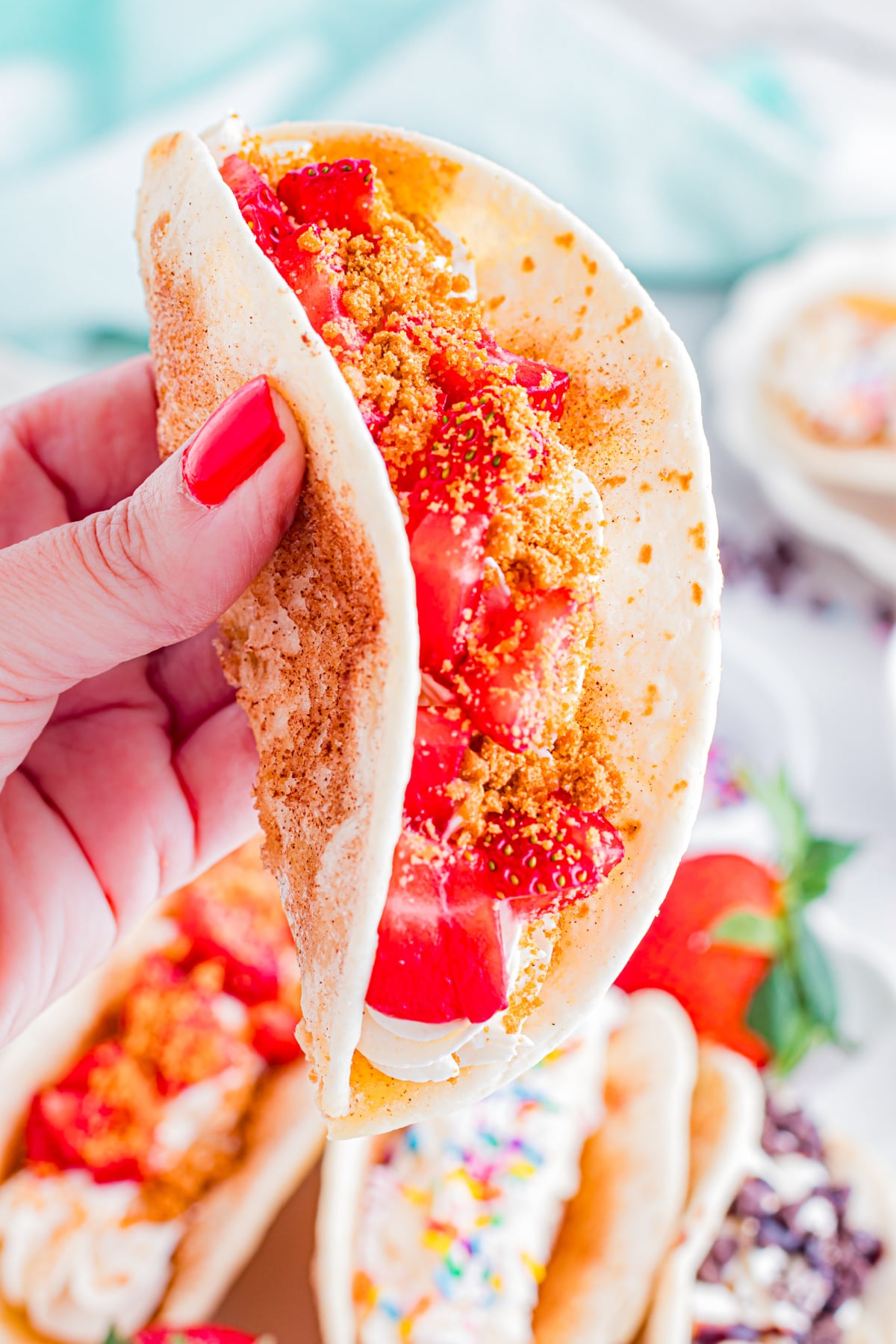 A dessert taco with cream and strawberries.
