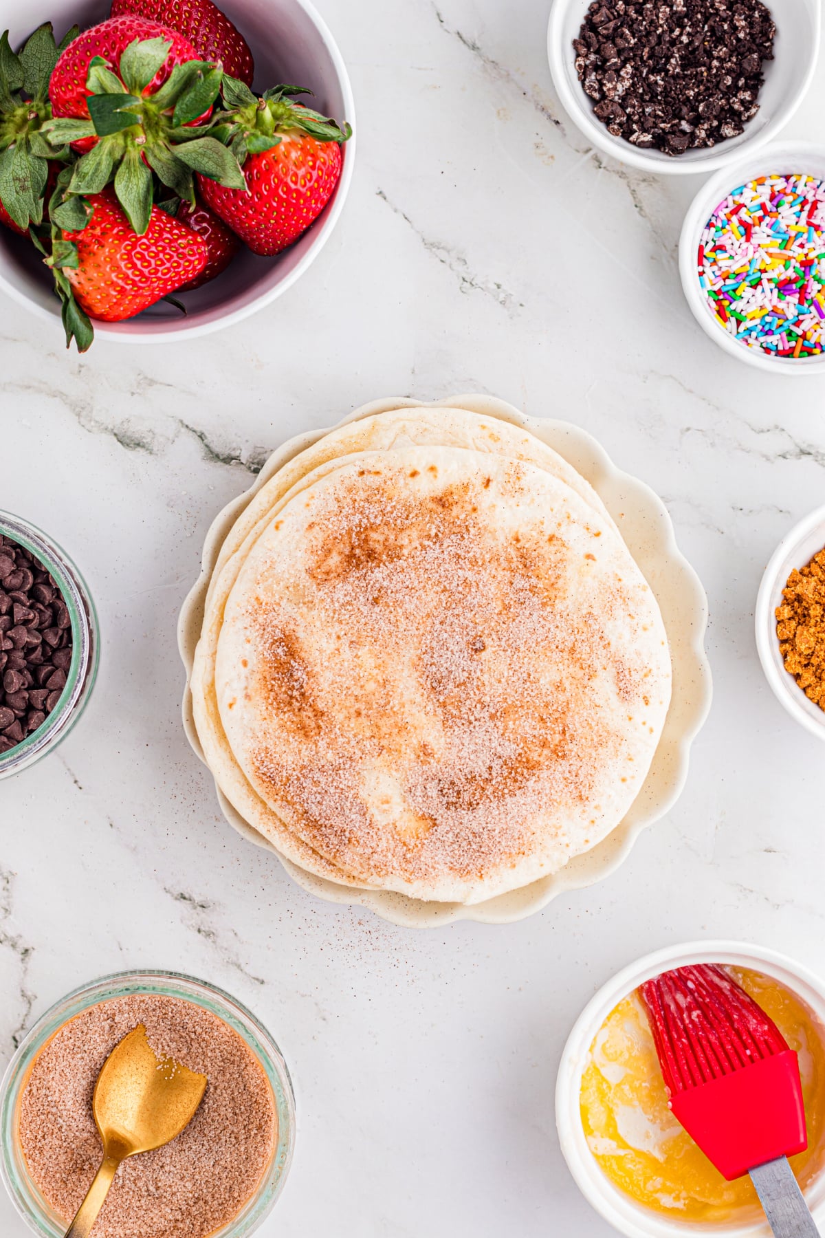 Tortillas topped with butter and cinnamon sugar.