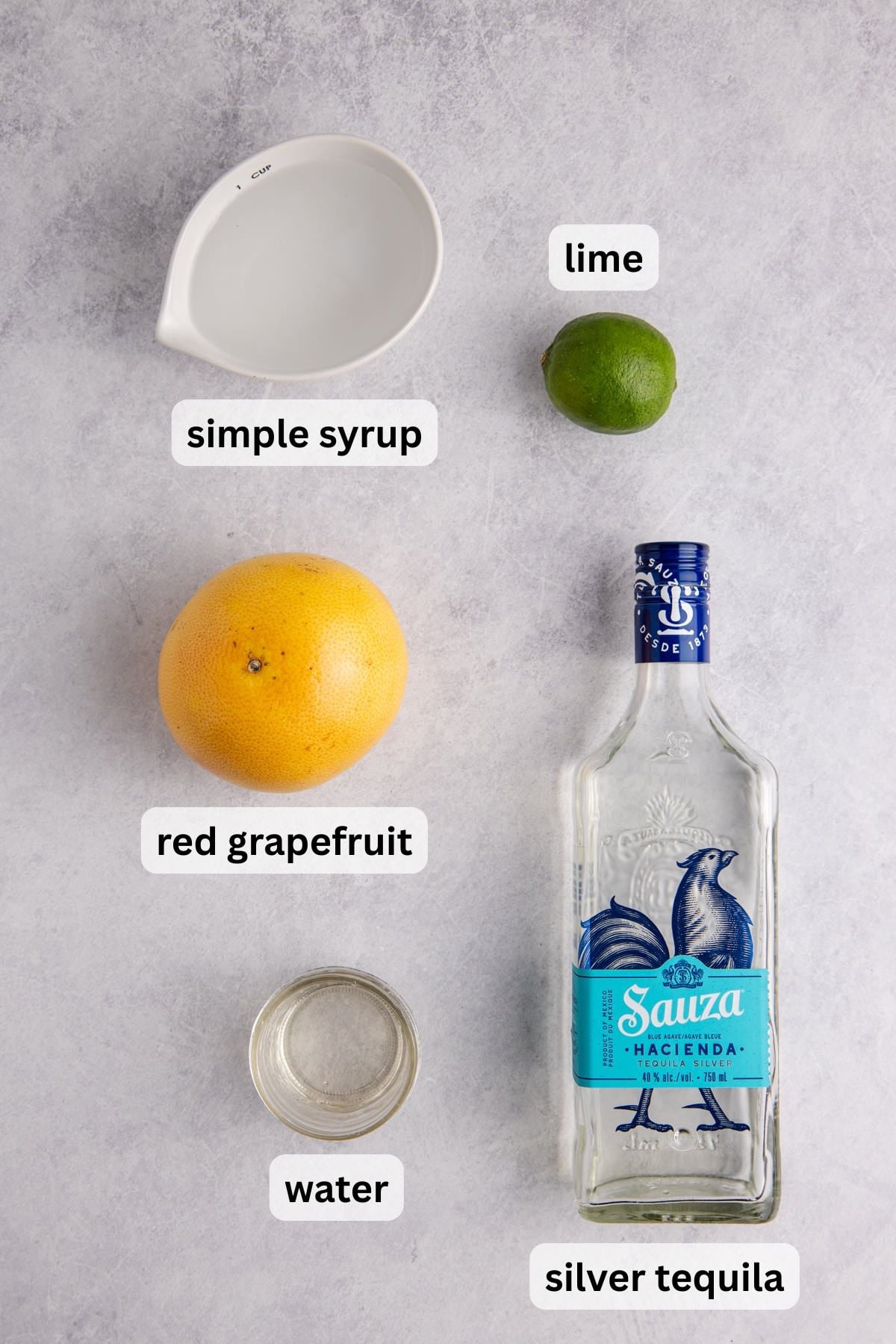 All the ingredients needed to make this frozen paloma drink in bowls on a table.