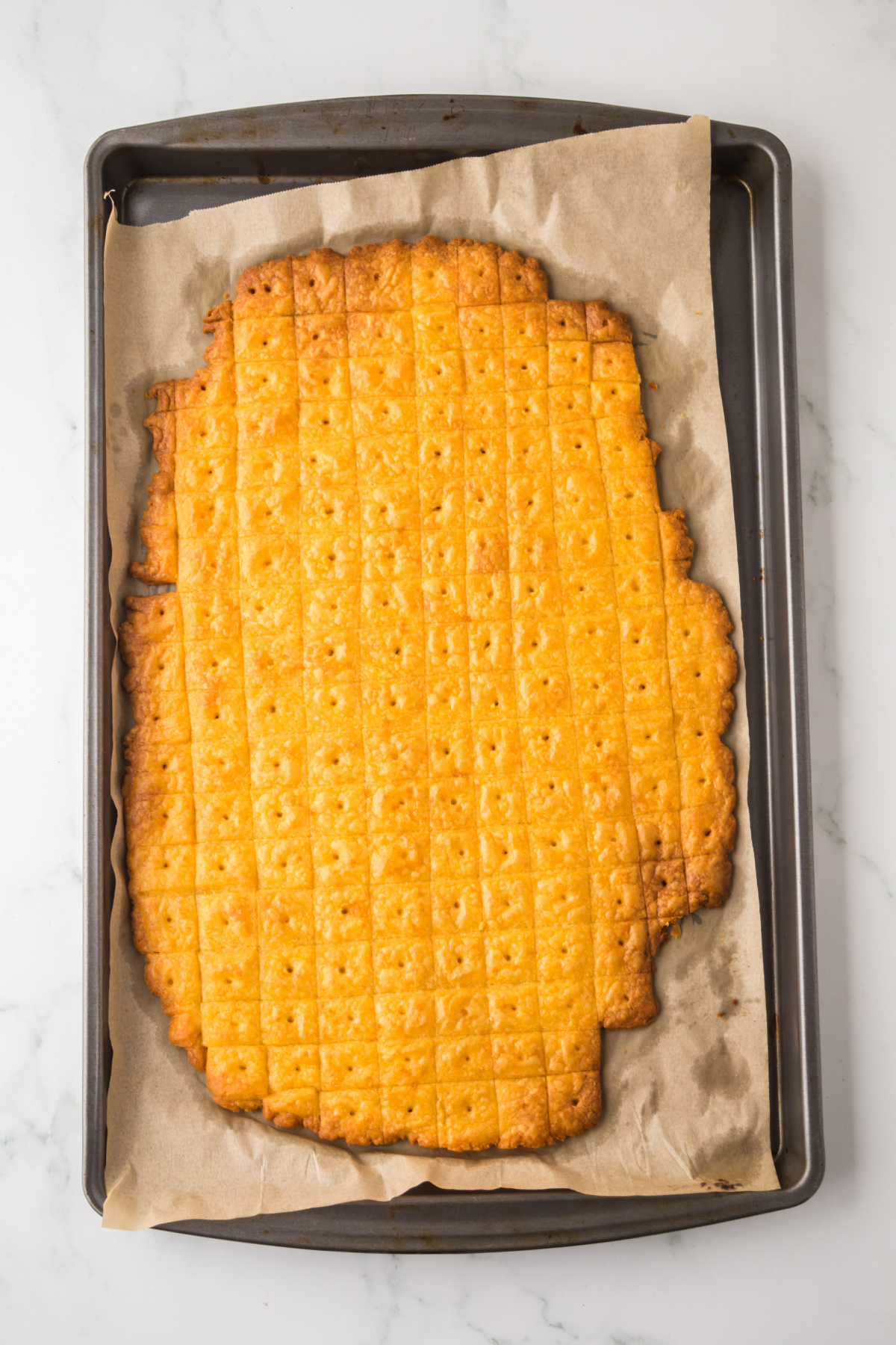 Cheez it dough baked on parchment covered baking sheet.
