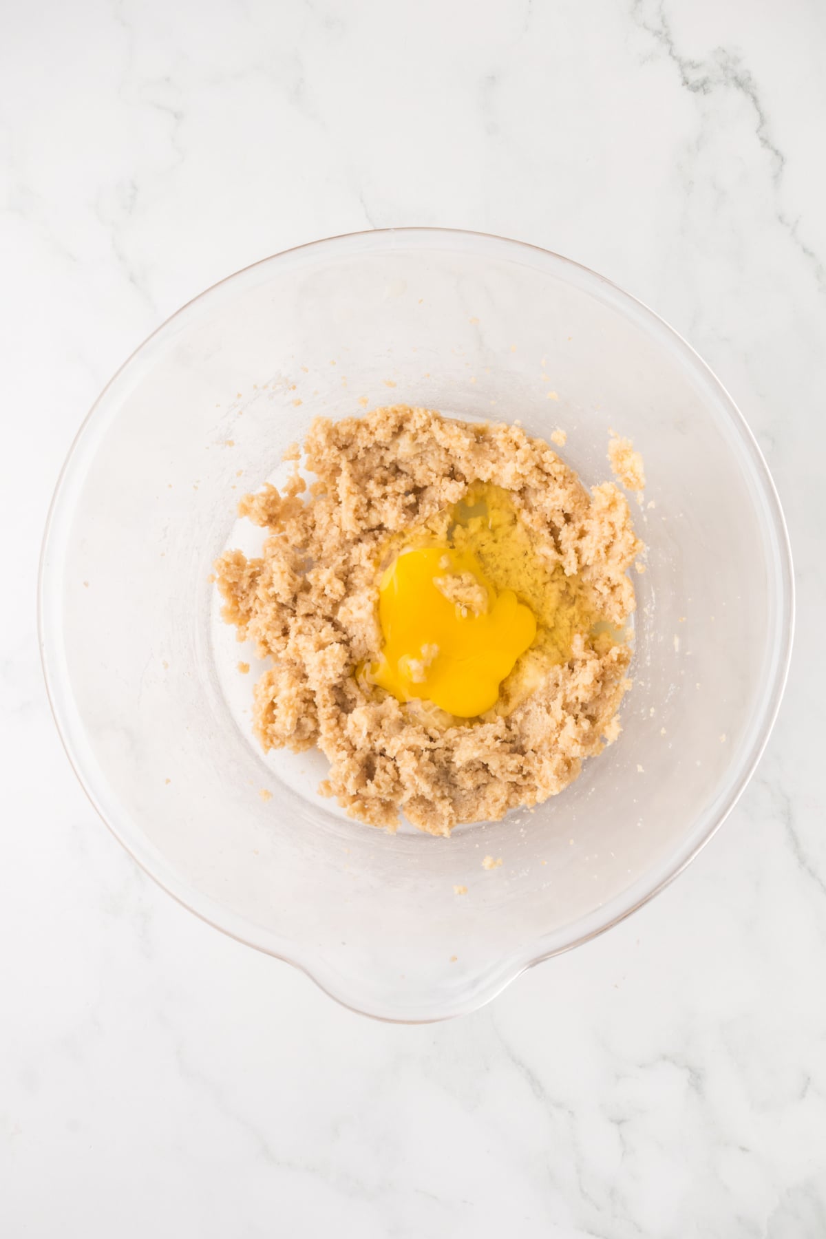Butter, eggs, white and brown sugar in a bowl.