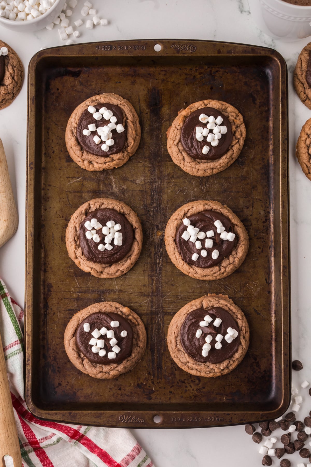 Ganache filled to the middle of the cookie and marshmallows on top.