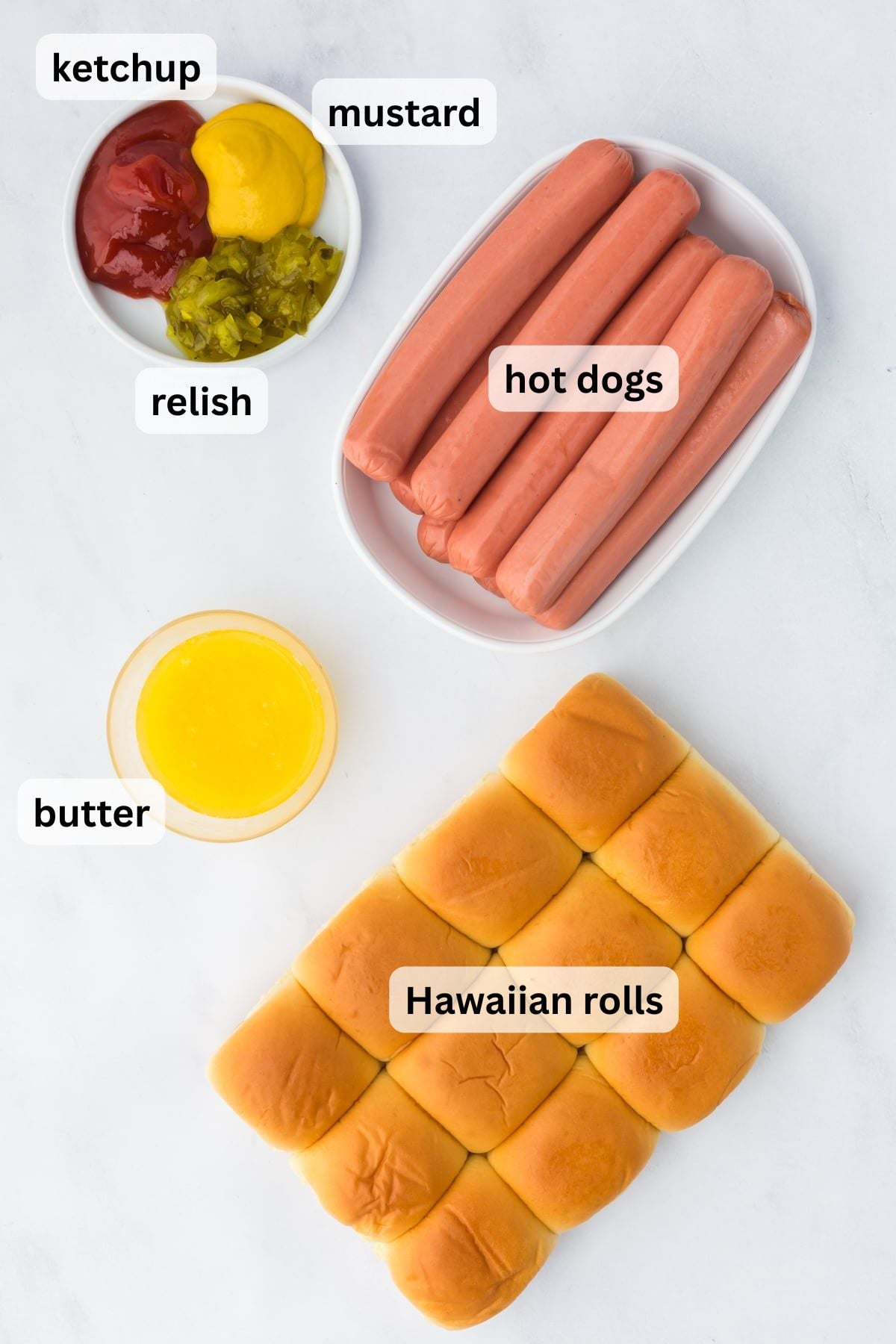 All the ingredients to make Hot Dog Sliders in bowls on a table