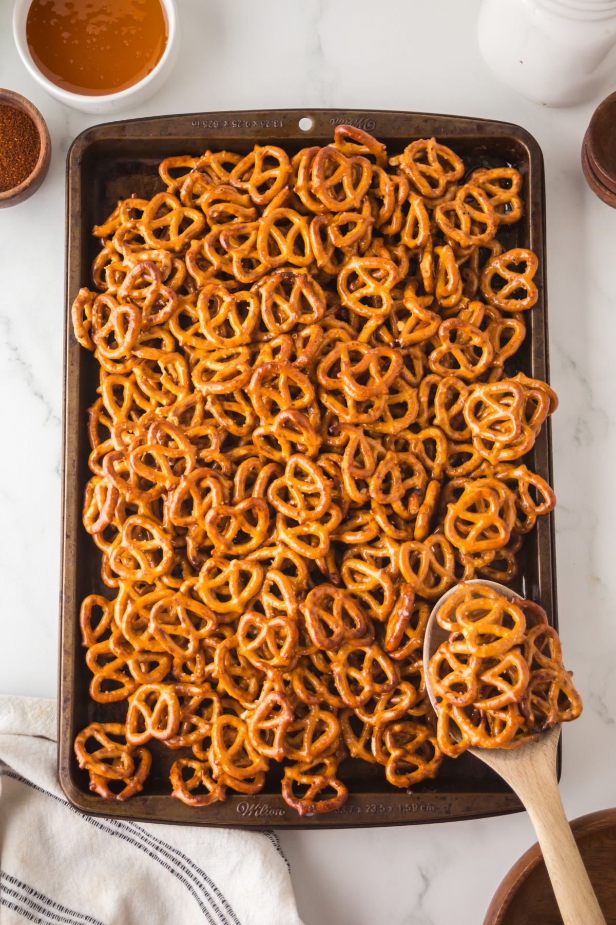 A baking pan full of baked hot honey pretzels on a counter.
