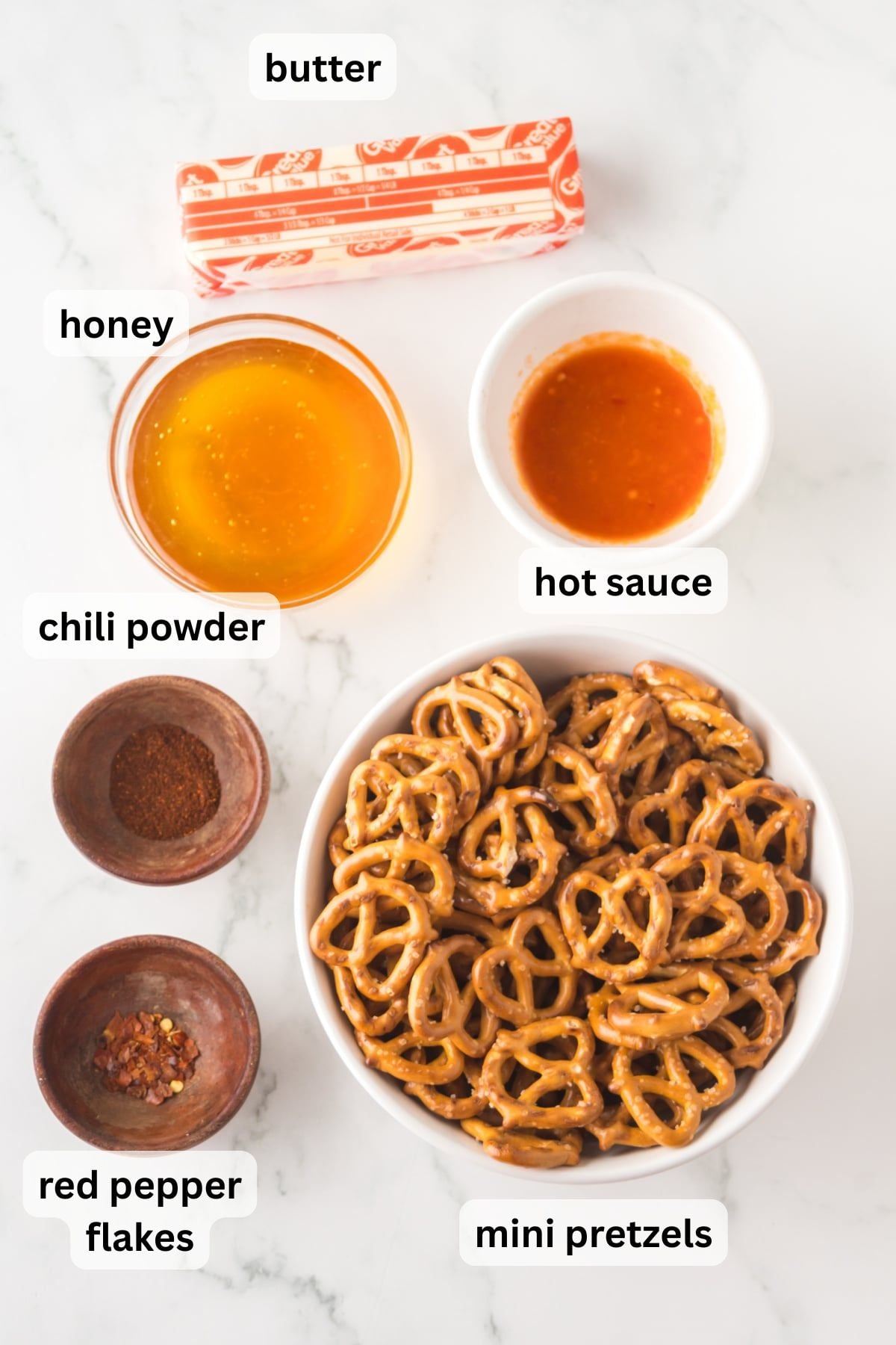 All of the ingredients needed to make Hot Honey Pretzels in bowls on a table.