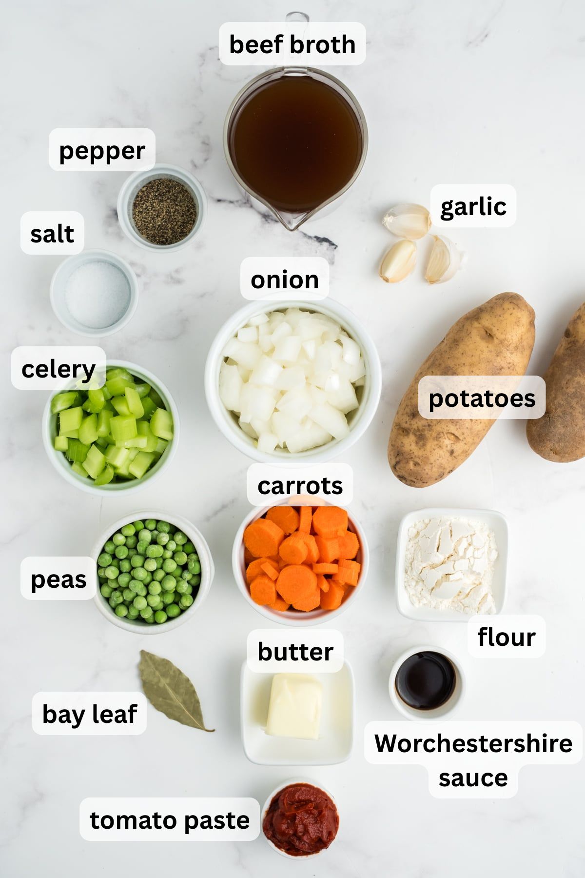 All the ingredients needed to make this stew in bowls on a table