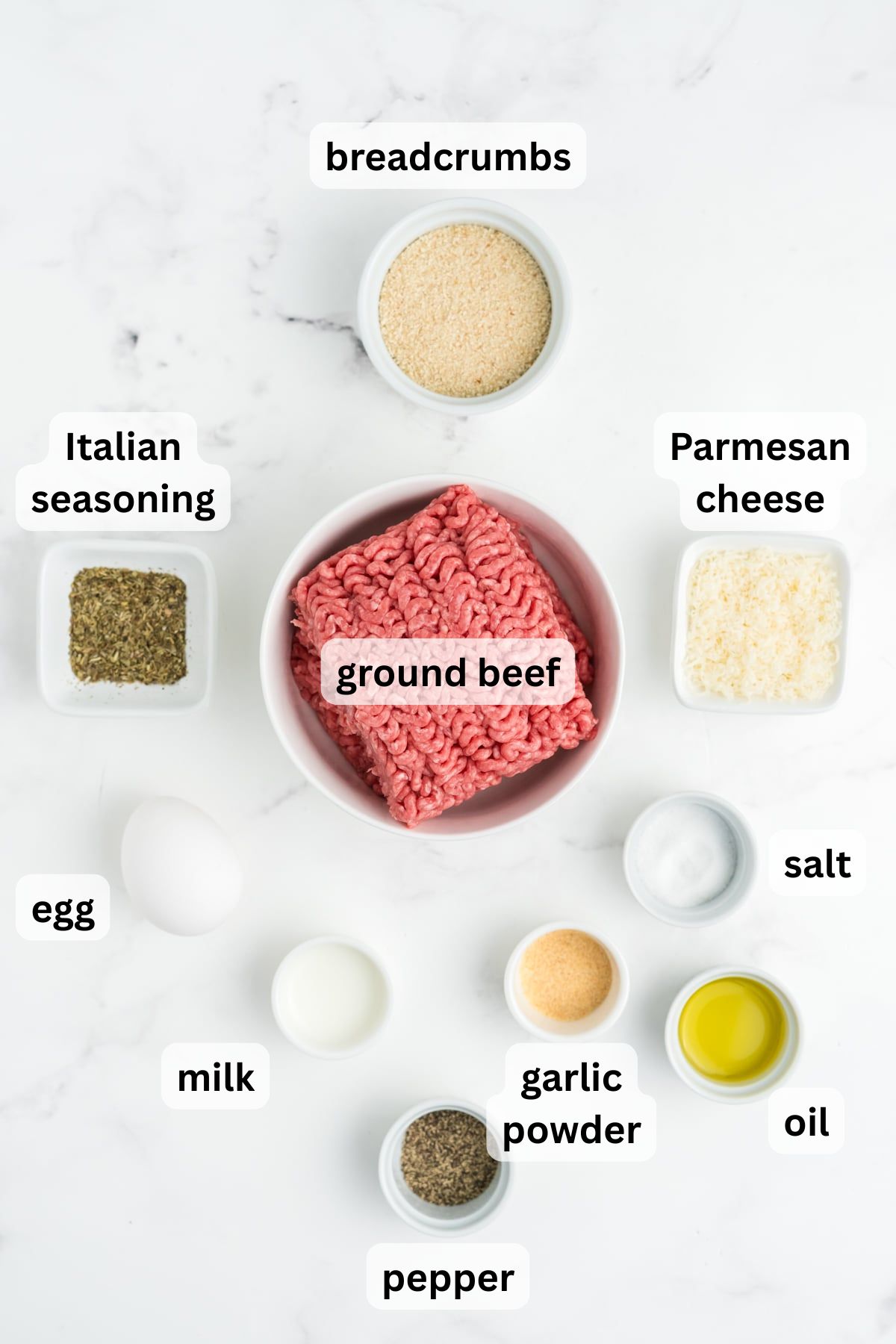 All the ingredients needed to make meatball stew in bowls on a table.