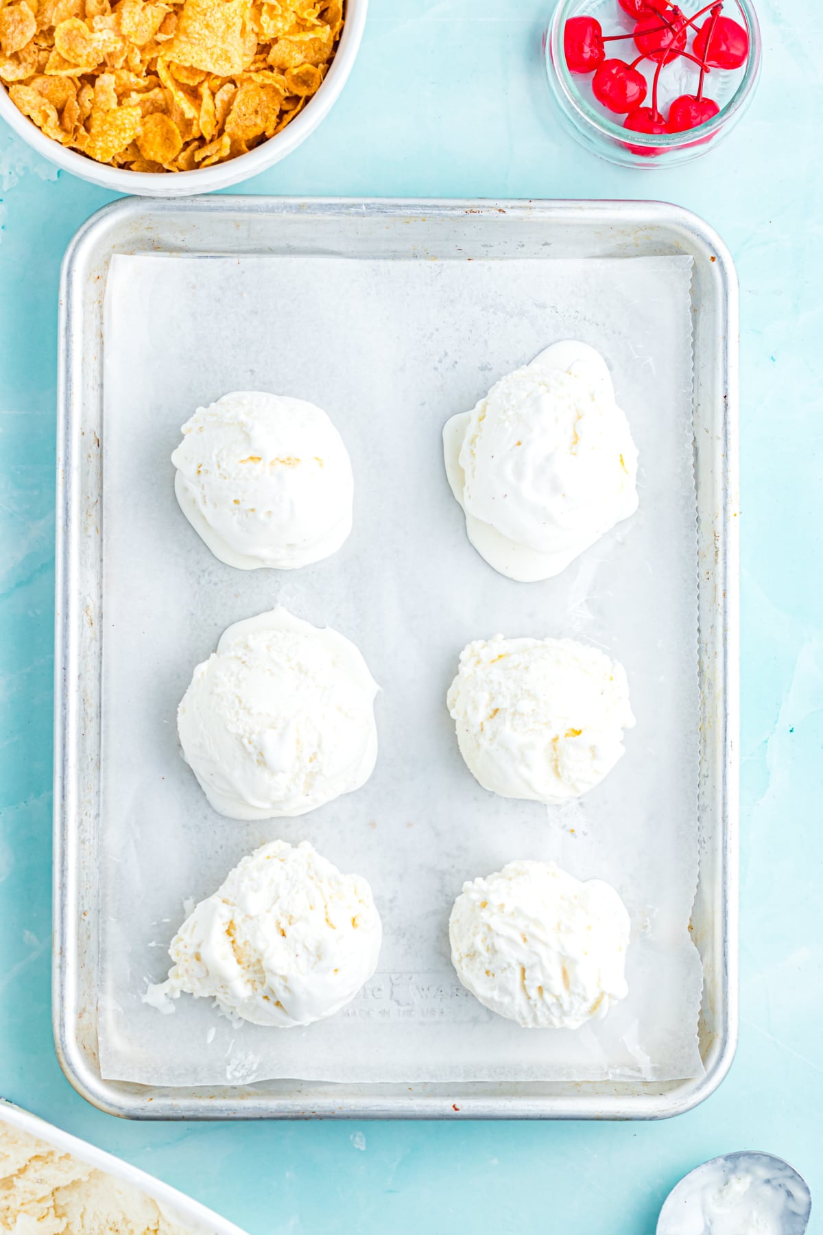 Vanilla ice cream scooped onto a baking tray.