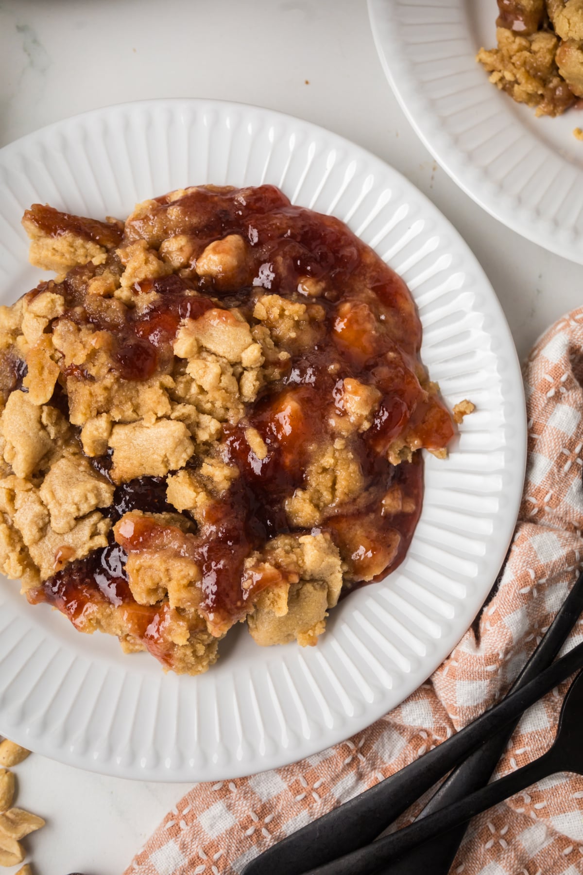 a serving of warm cobbler with soft cookie topping on a plate