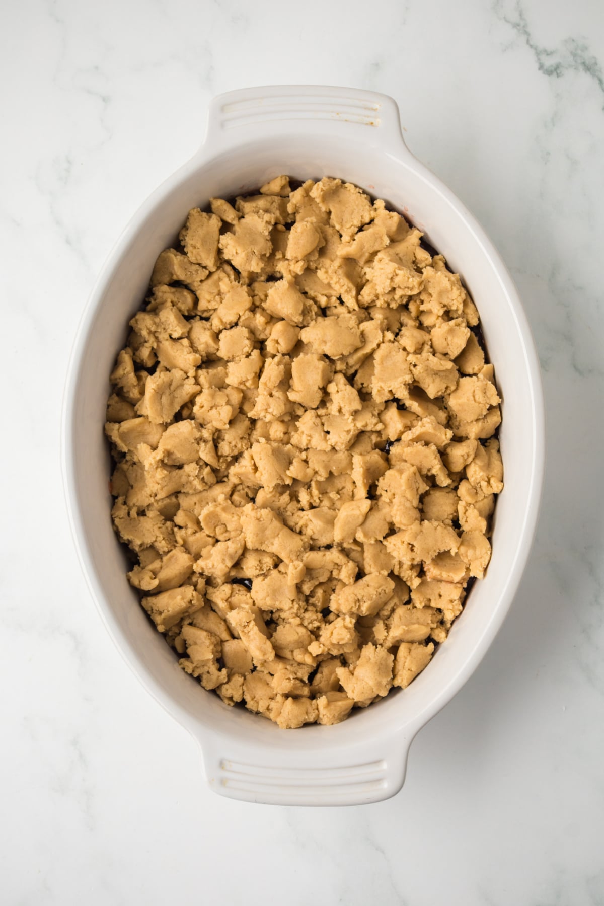 topping jelly with peanut butter dough before baking in dish