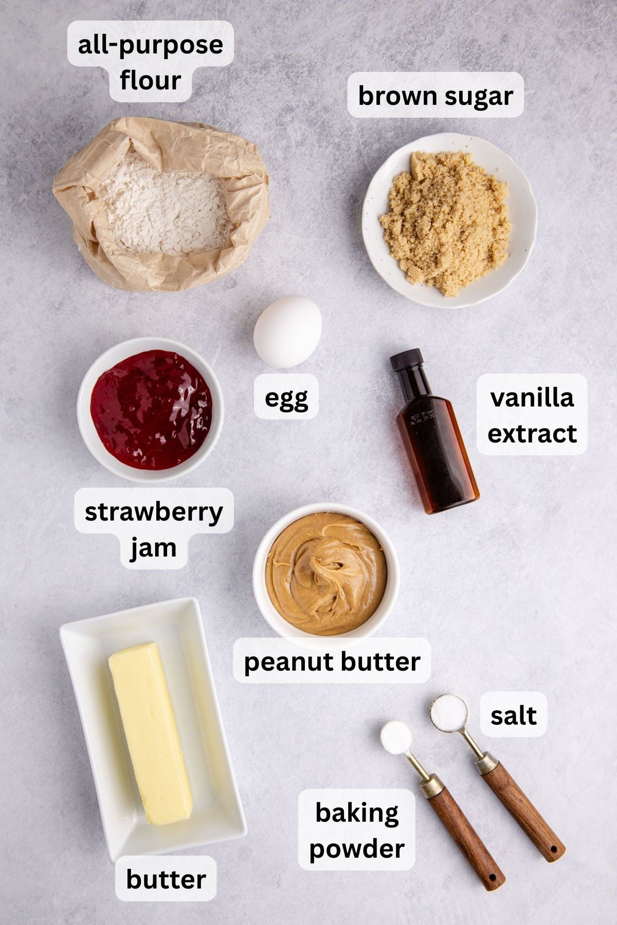 All the ingredients to make Peanut Butter And Jelly Bars in bowls on a table