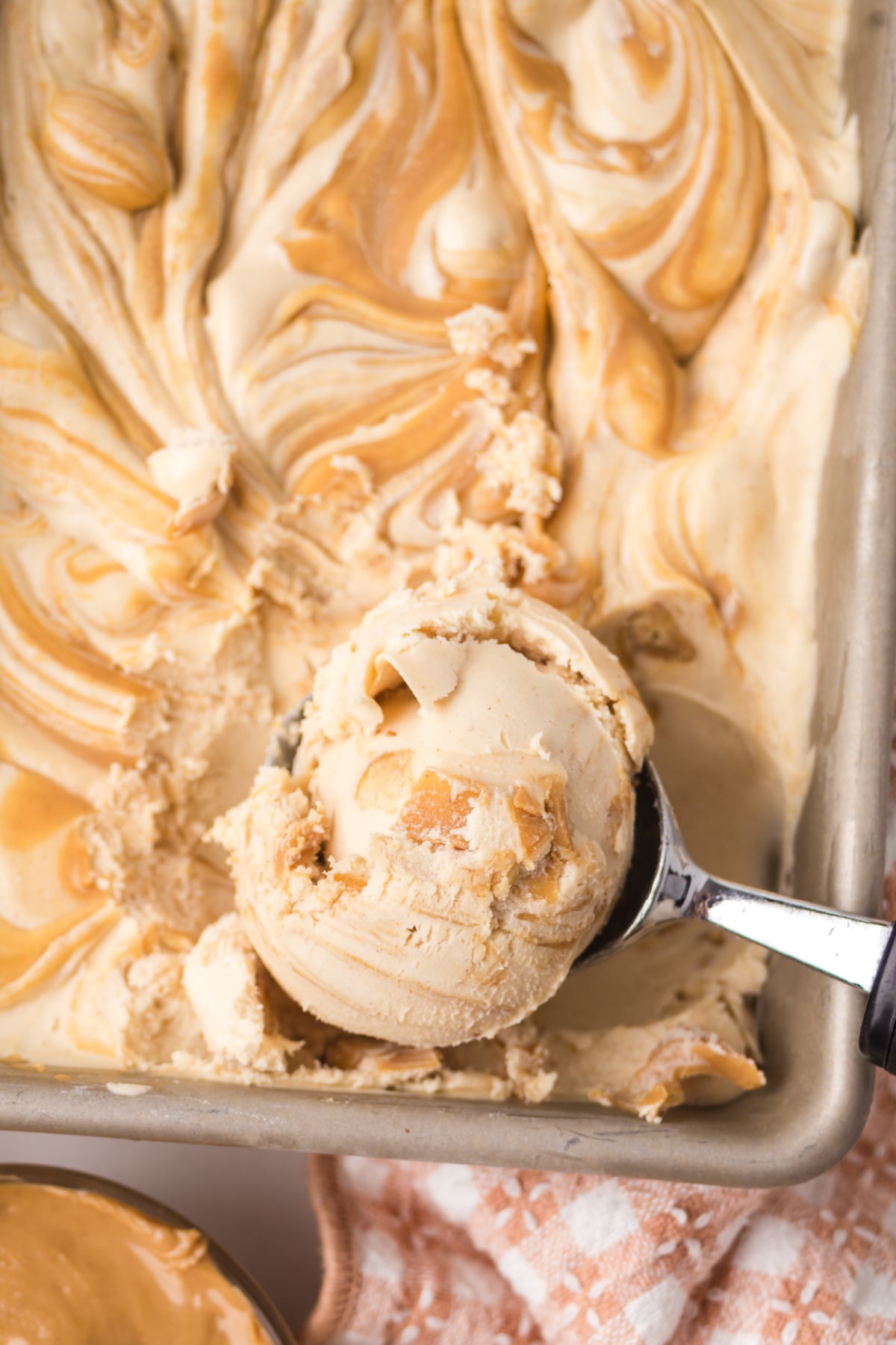 A scoop of Ice Cream Recipe in the pan with the scoop.