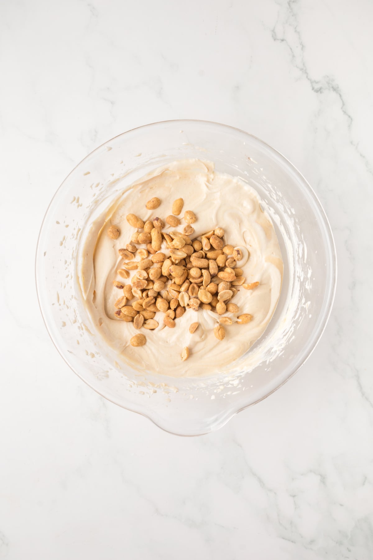 All of the needed mix-ins in a bowl with whipped cream ready to be folded in.