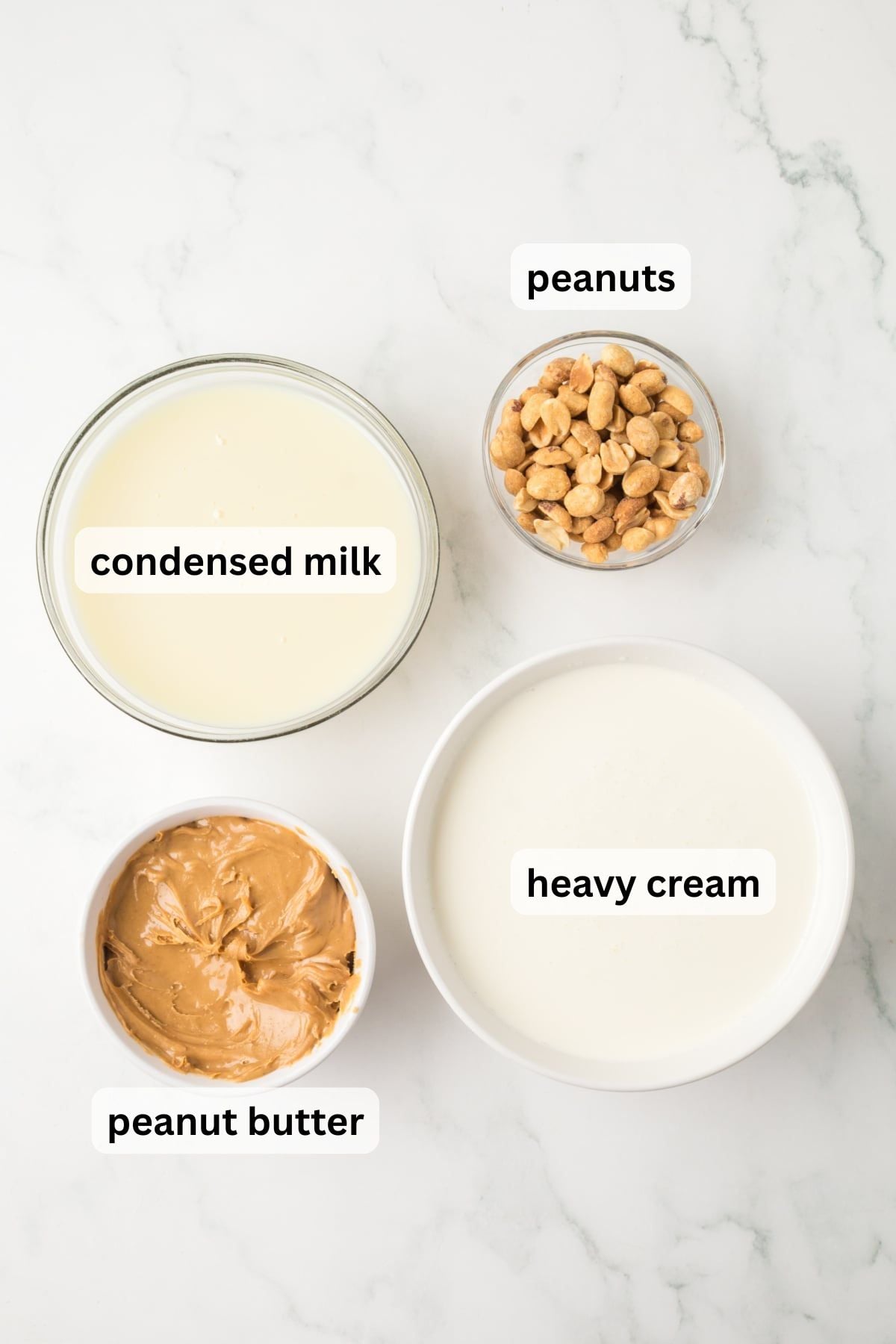All the ingredients needed to make Peanut Butter Ice Cream in bowls on a table