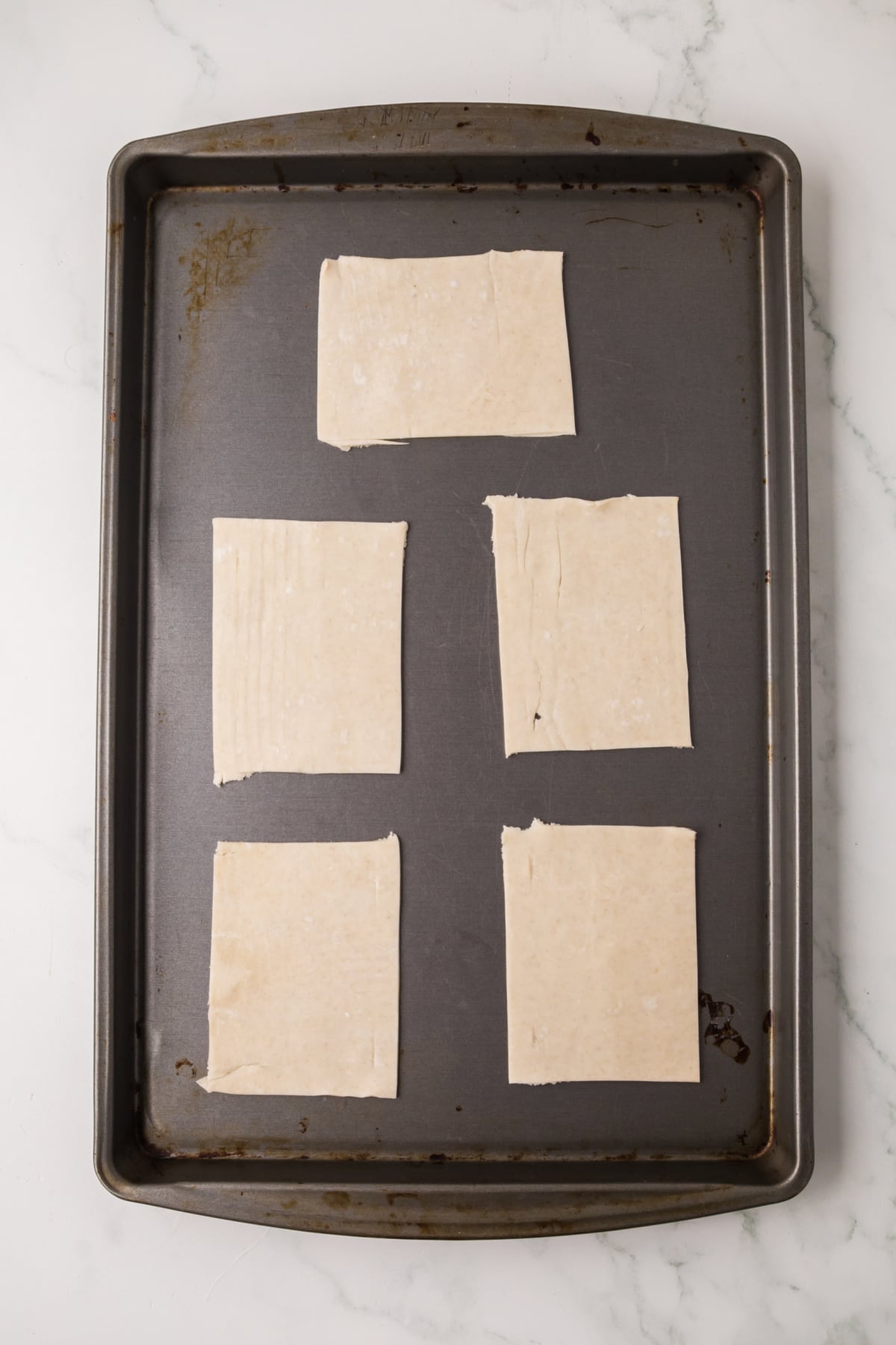 Bottom pop tart layer on baking sheet.