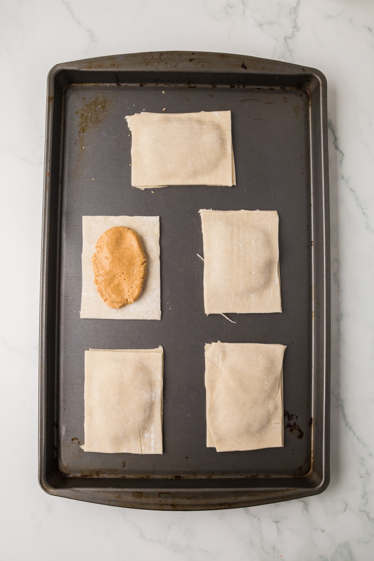 Peanut butter mixture added to bottom half of tarts with one uncovered.