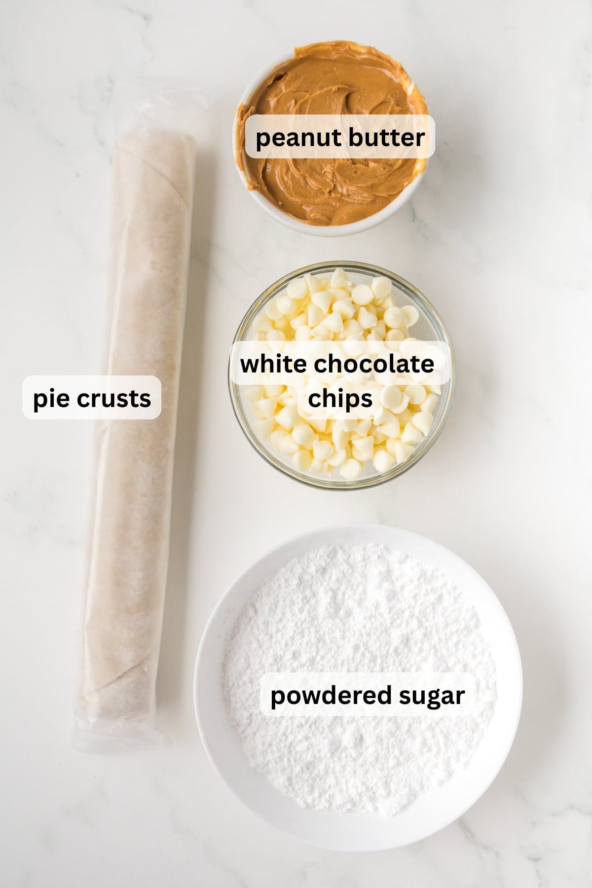 All the ingredients needed to make Peanut Butter Pop Tarts in bowls on a table.