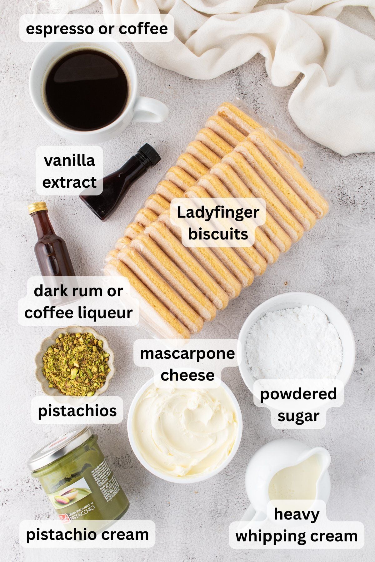 Ingredients for Pistachio Tiramisu on a table in bowls.