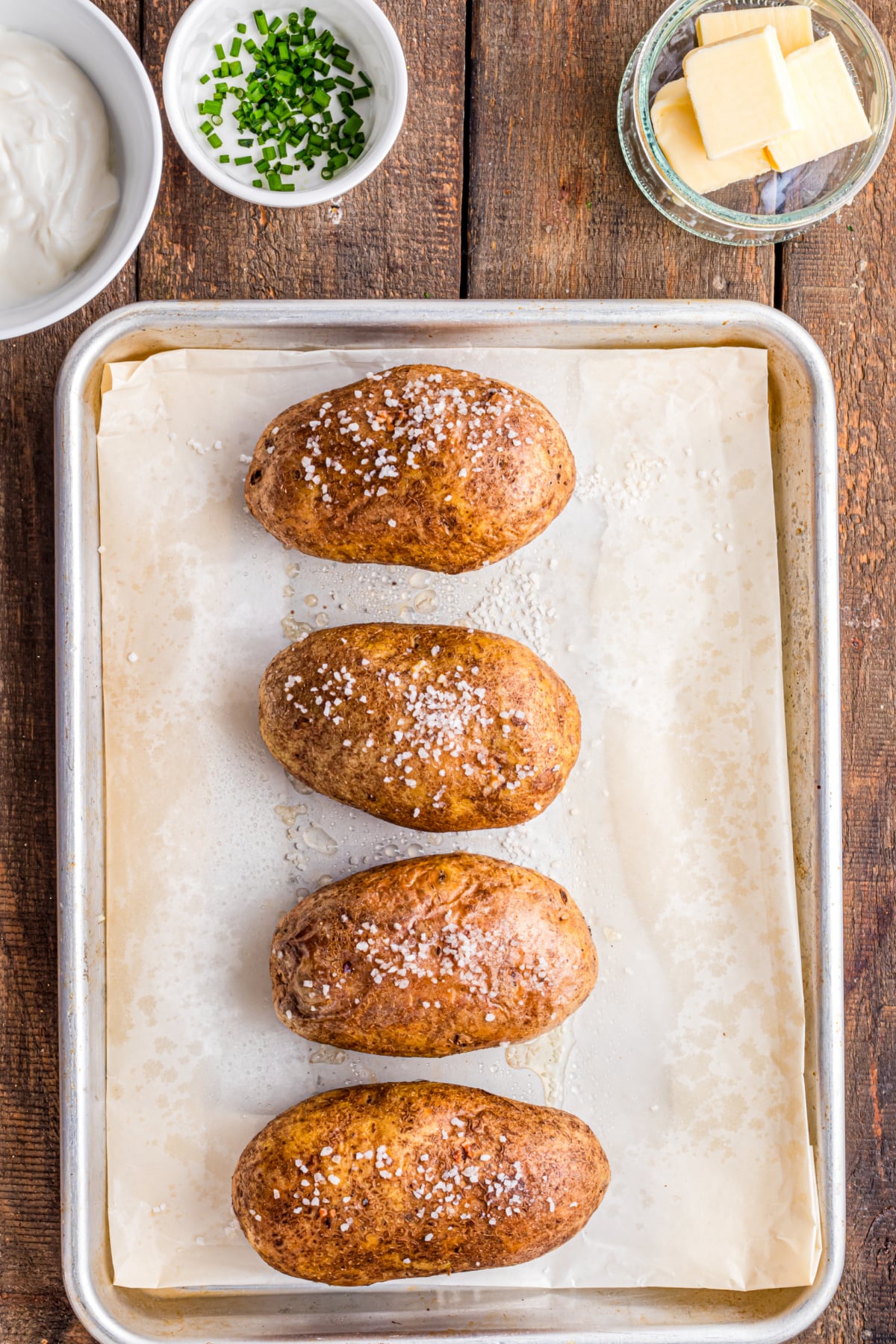 Baked potatoes on the baking sheet.