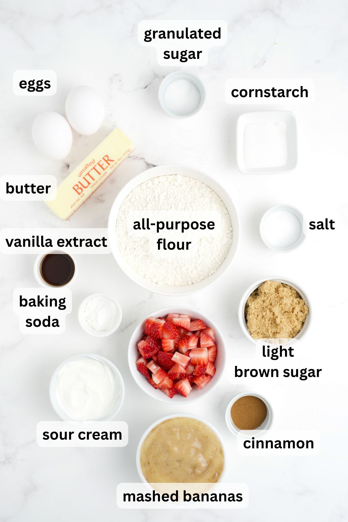 Ingredients for Strawberry Banana Bread in bowls on a table