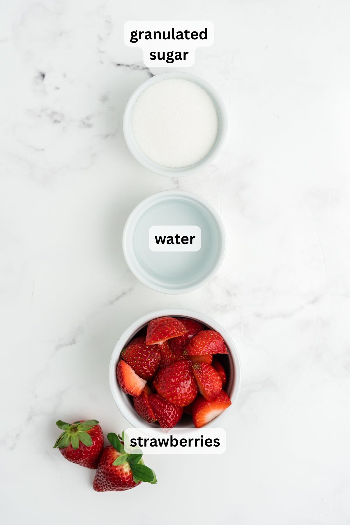 Ingredients for strawberry simple syrup on a table