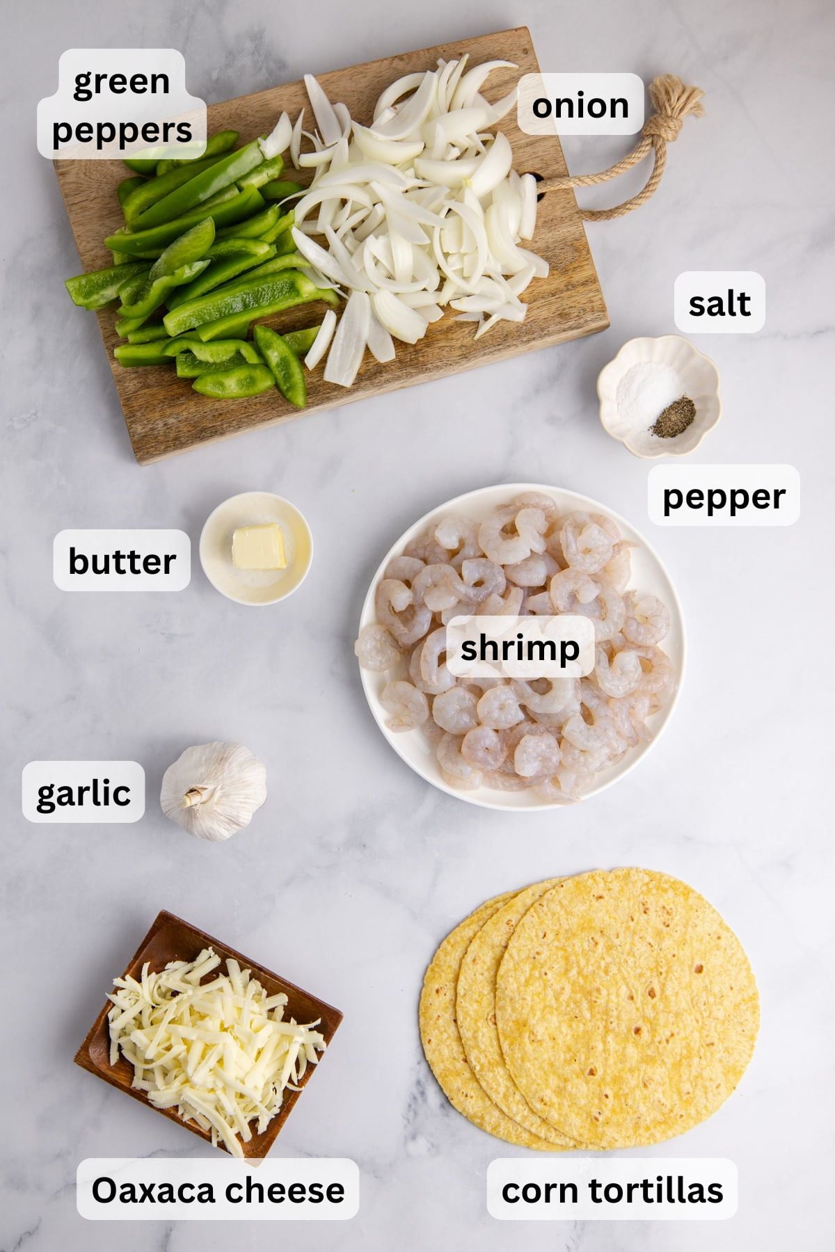 All the ingredients needed to make taco gobernador in bowls on a table.