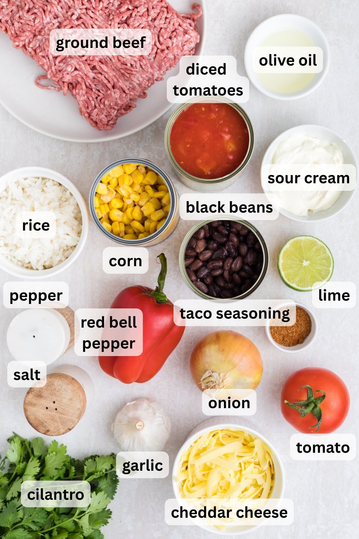 All the ingredients needed to make this taco rice in bowls on a table.