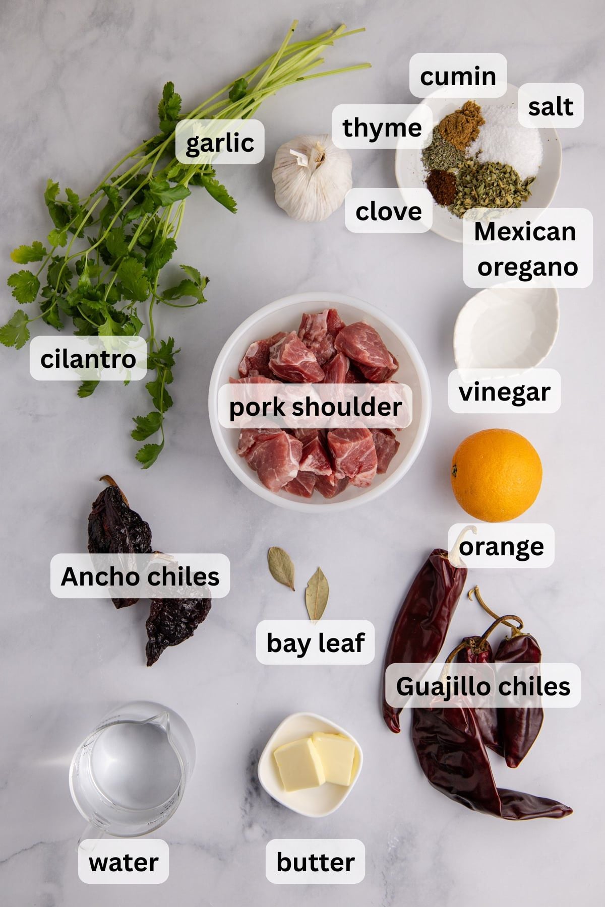 All the ingredients needed to make pork asado in bowls on a table.