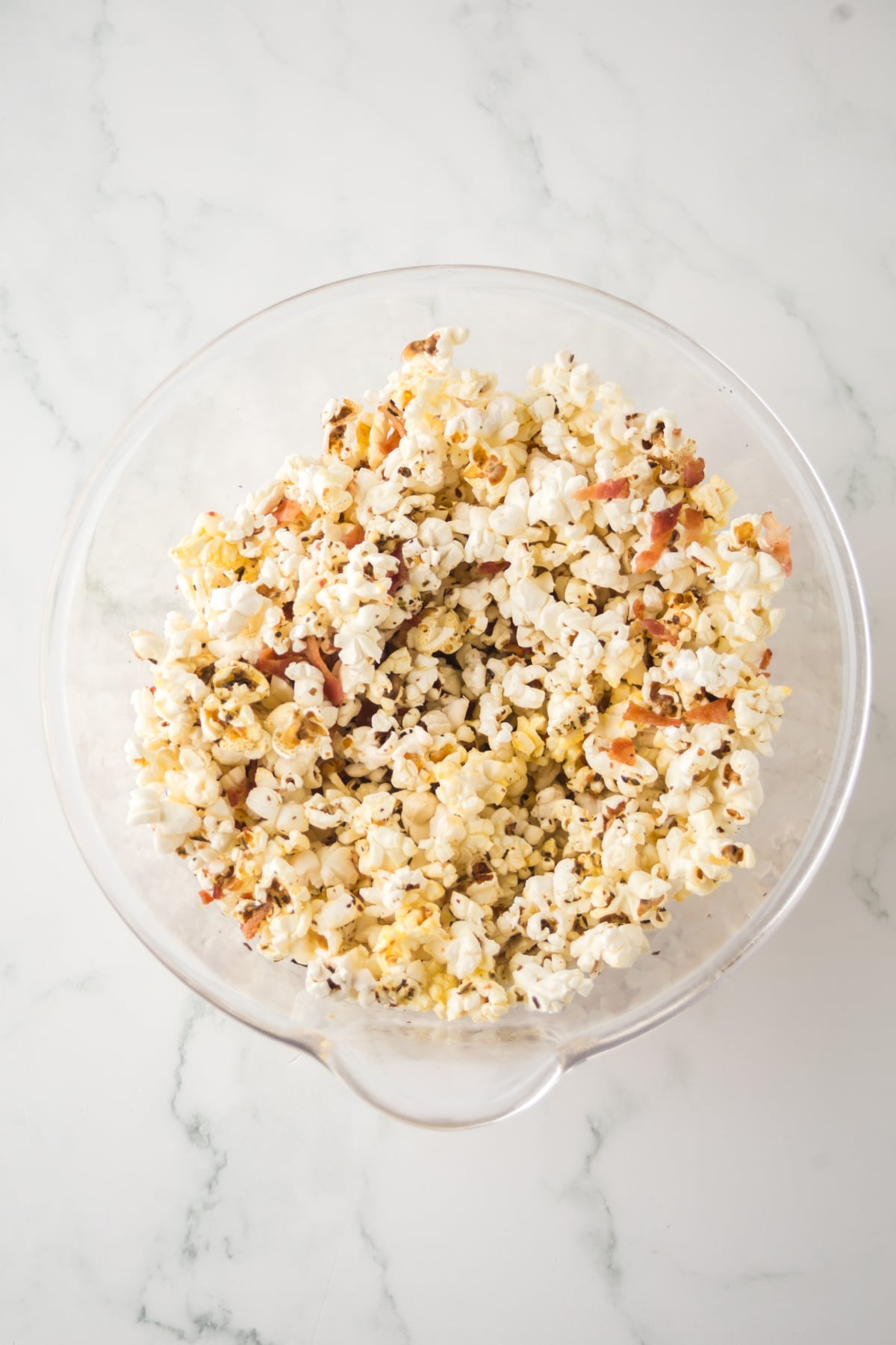 Popcorn blended with ingredients in a bowl.