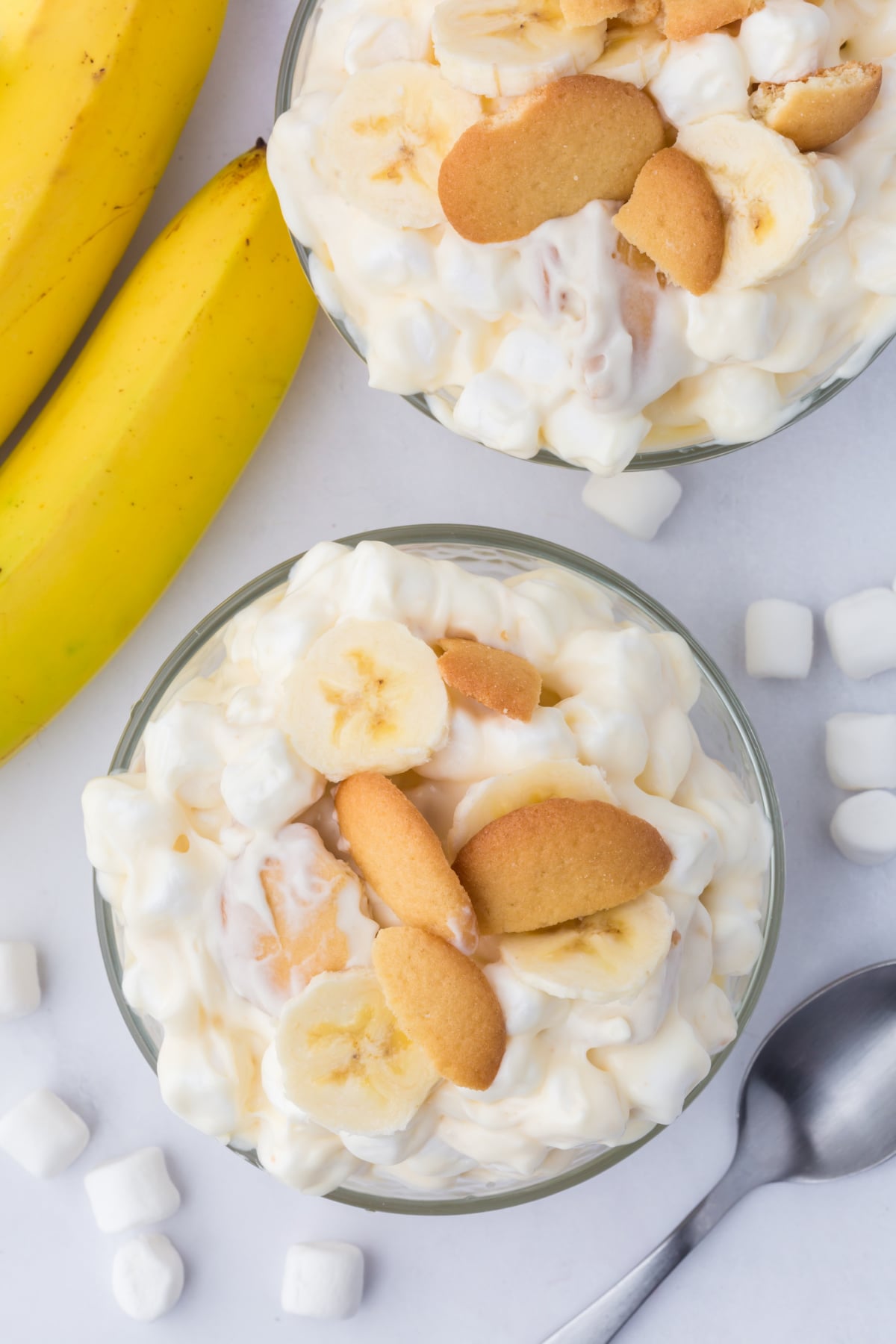 banana pudding fluff served in bowl topped with wafers and bananas on the counter