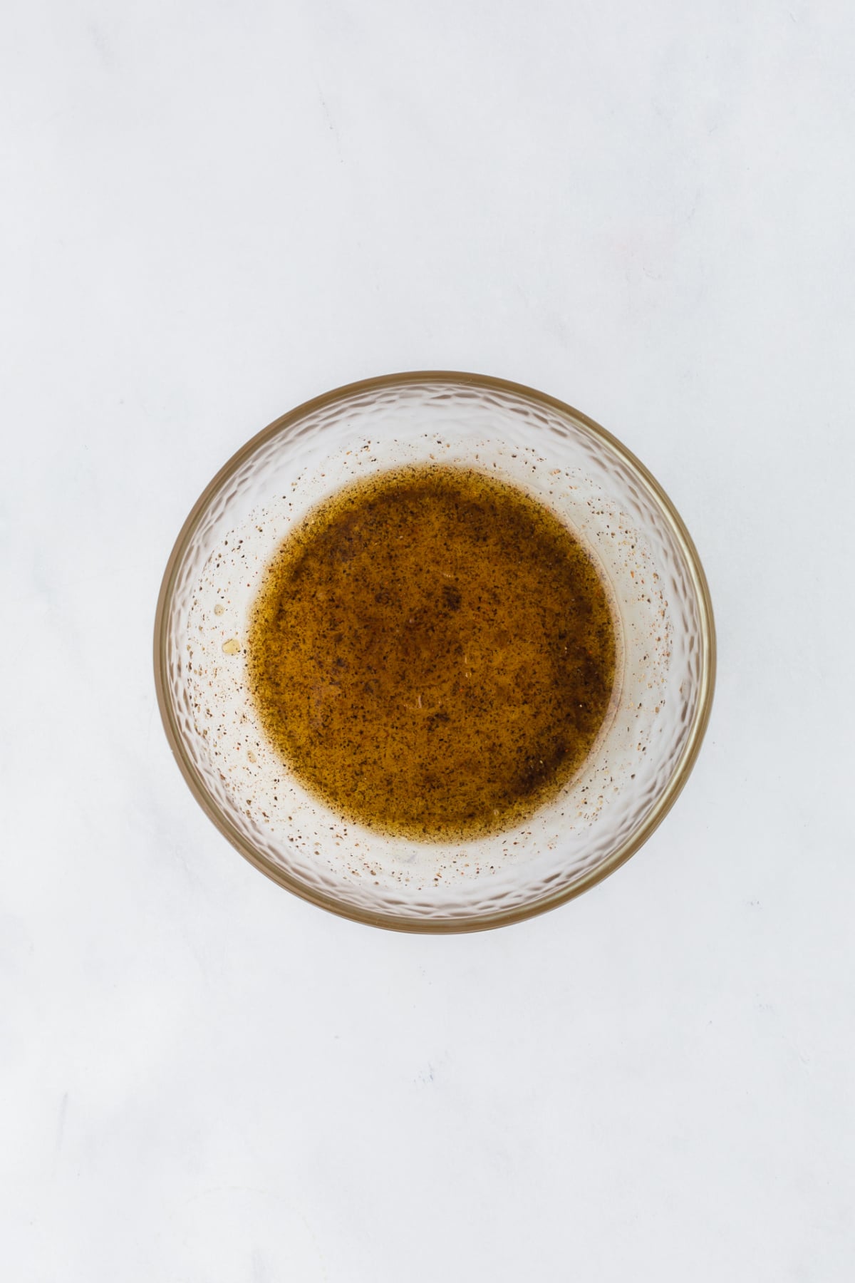 The dressing in bowl stirred and blended together.