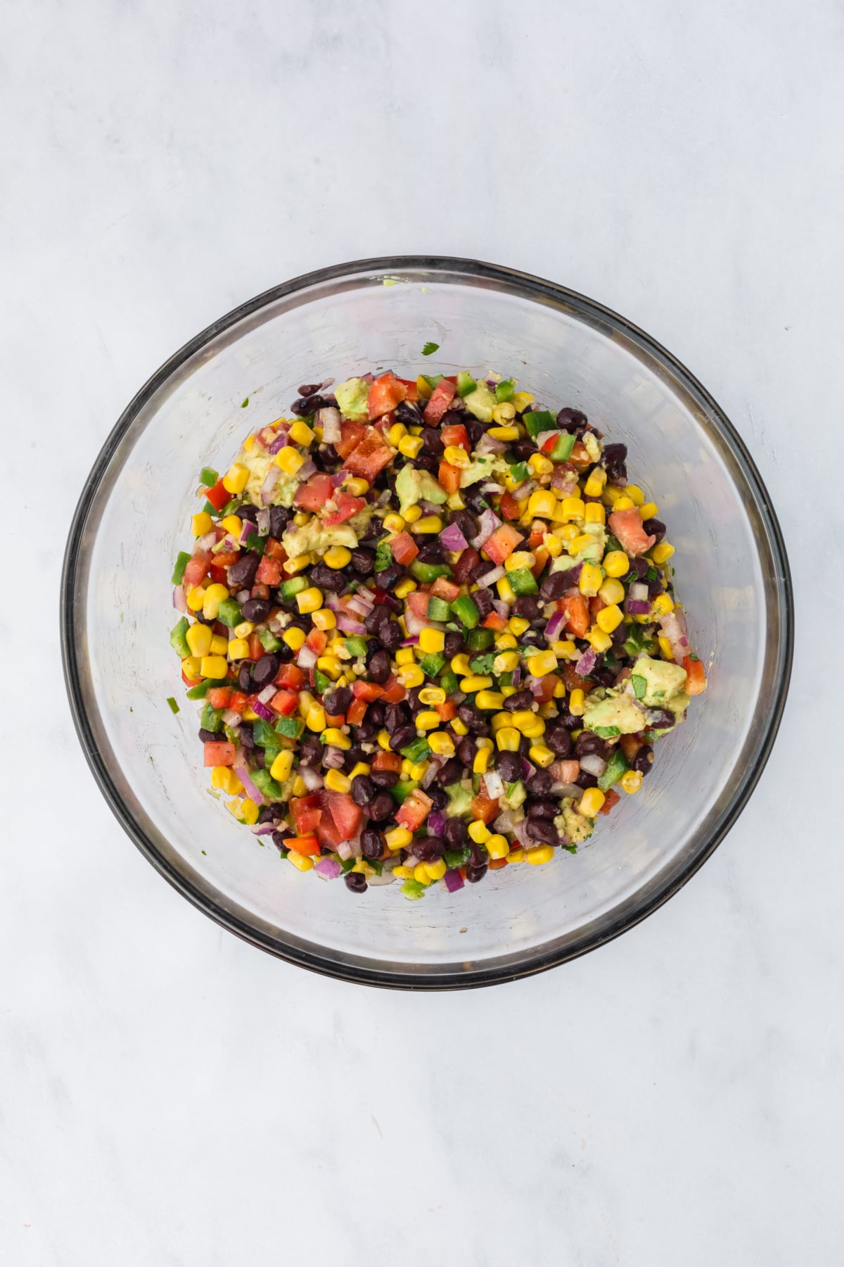 Salad ingredients blended together on a table.