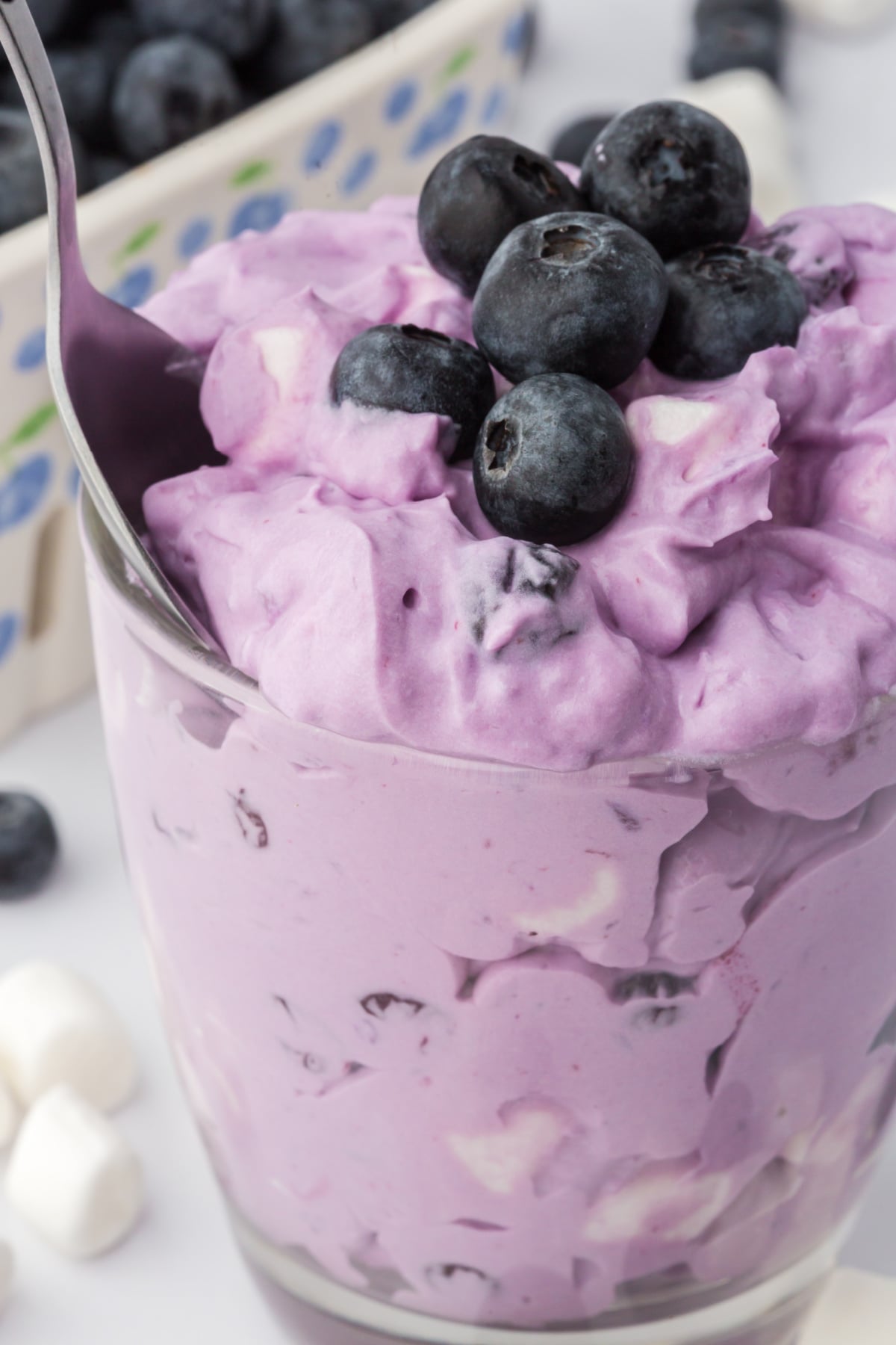 no bake blueberry fluff dessert in a cup with spoon