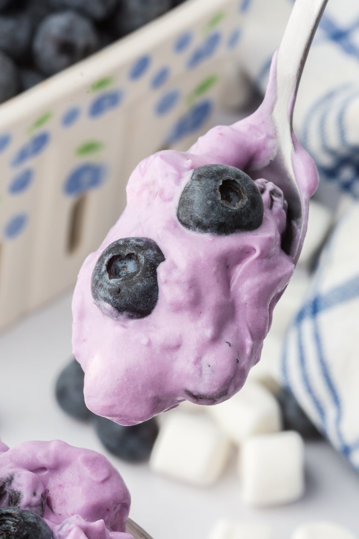 no bake blueberry fluff dessert in a cup on spoon