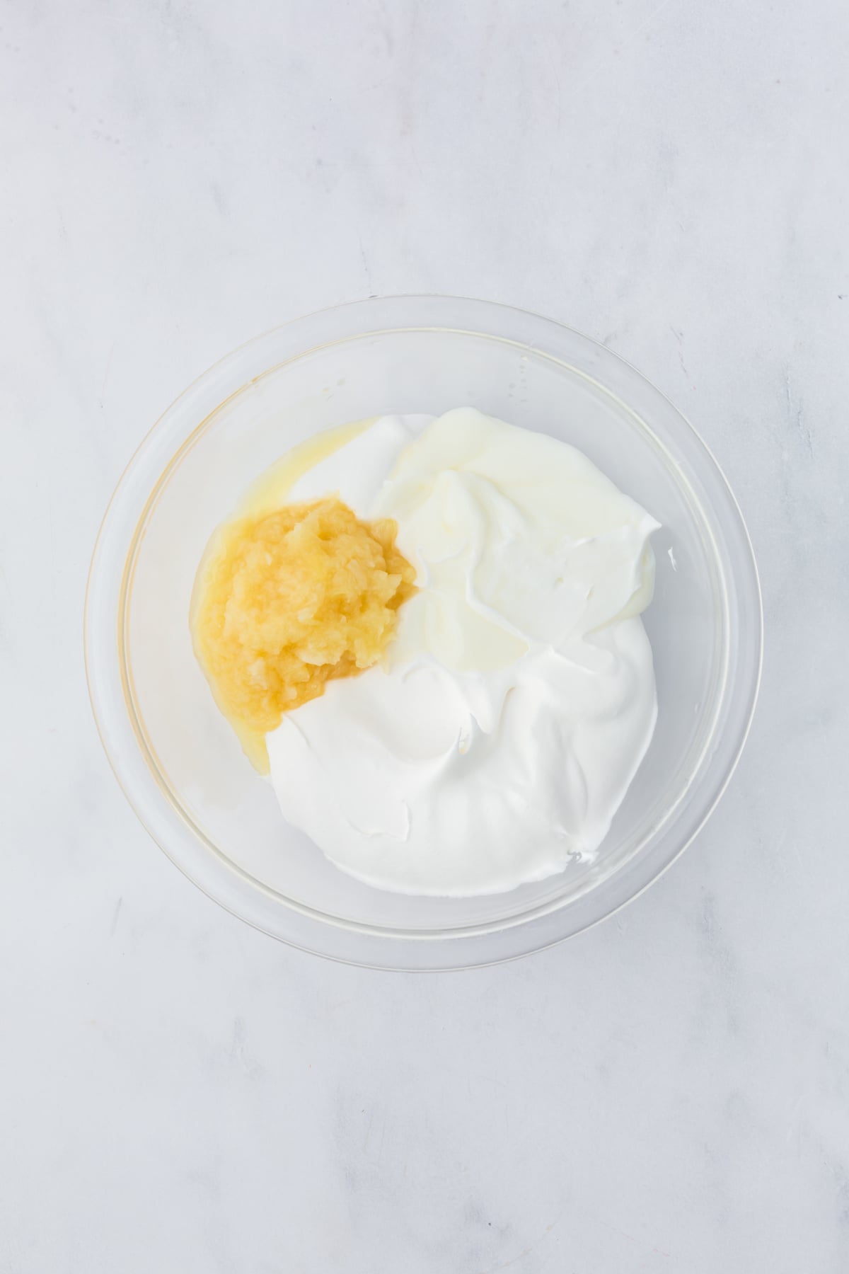 mixing whipped topping pineapple and yogurt for blueberry fluff